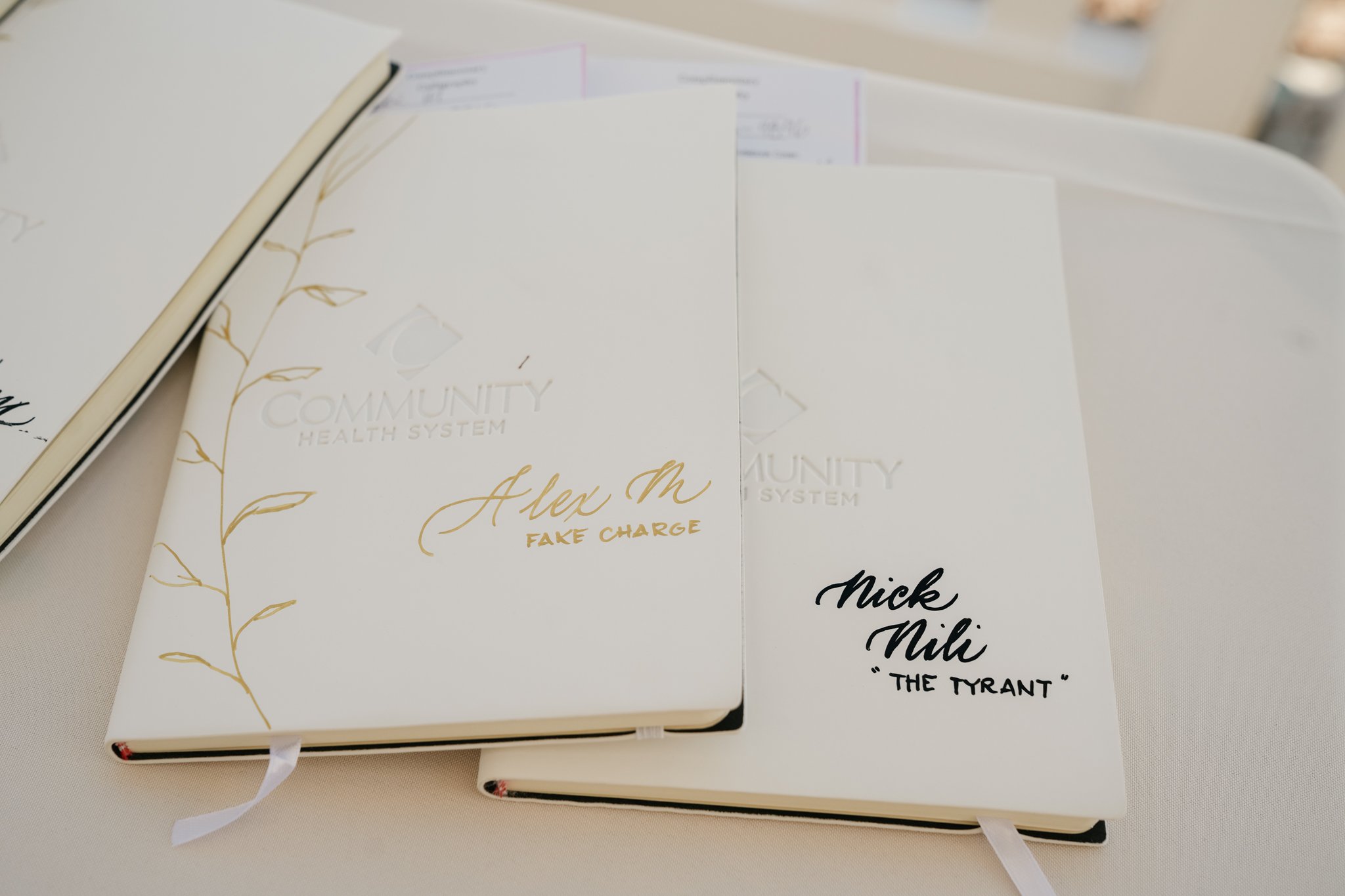 Hand-lettered notebook set designed as a personalized gift for an intimate California event.