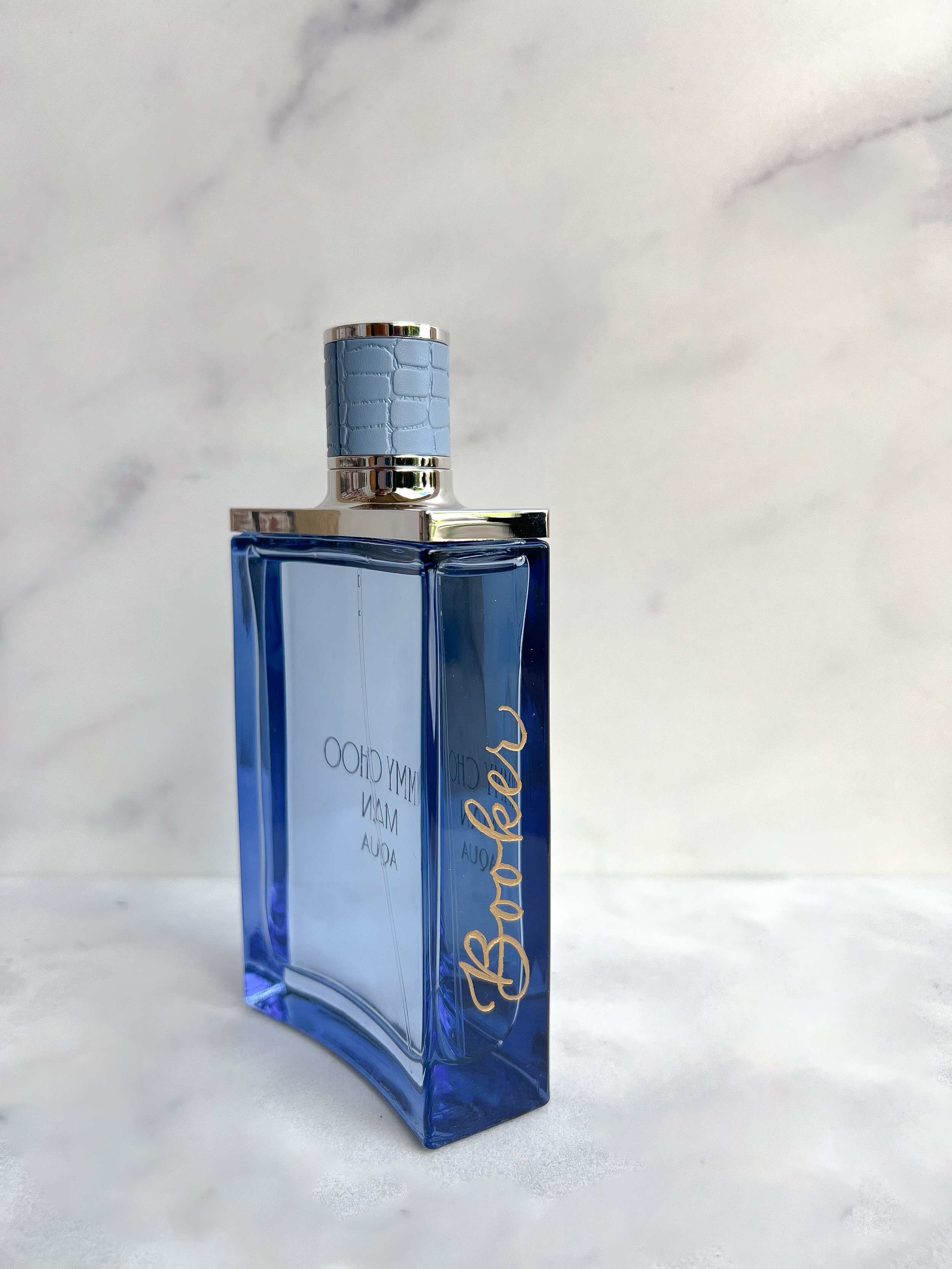 Engraved glass bottle personalized with calligraphy for milestone celebration guests.