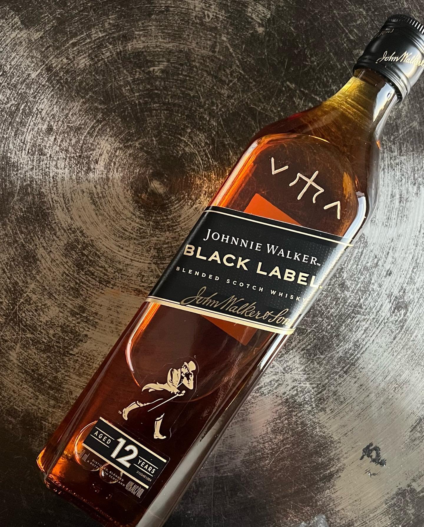 Pair of engraved liquor bottles featuring branded designs for a California brand activation.