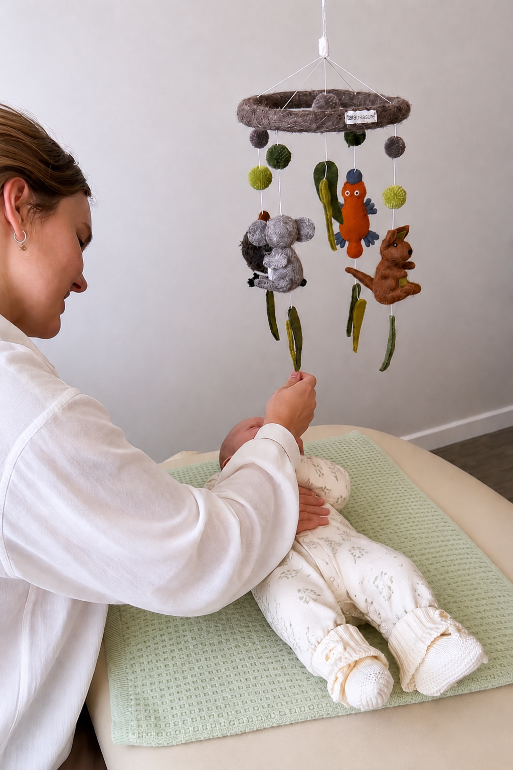 Paediatric osteopath gently treating a baby at Oasis Osteopathy & Co. in Busselton