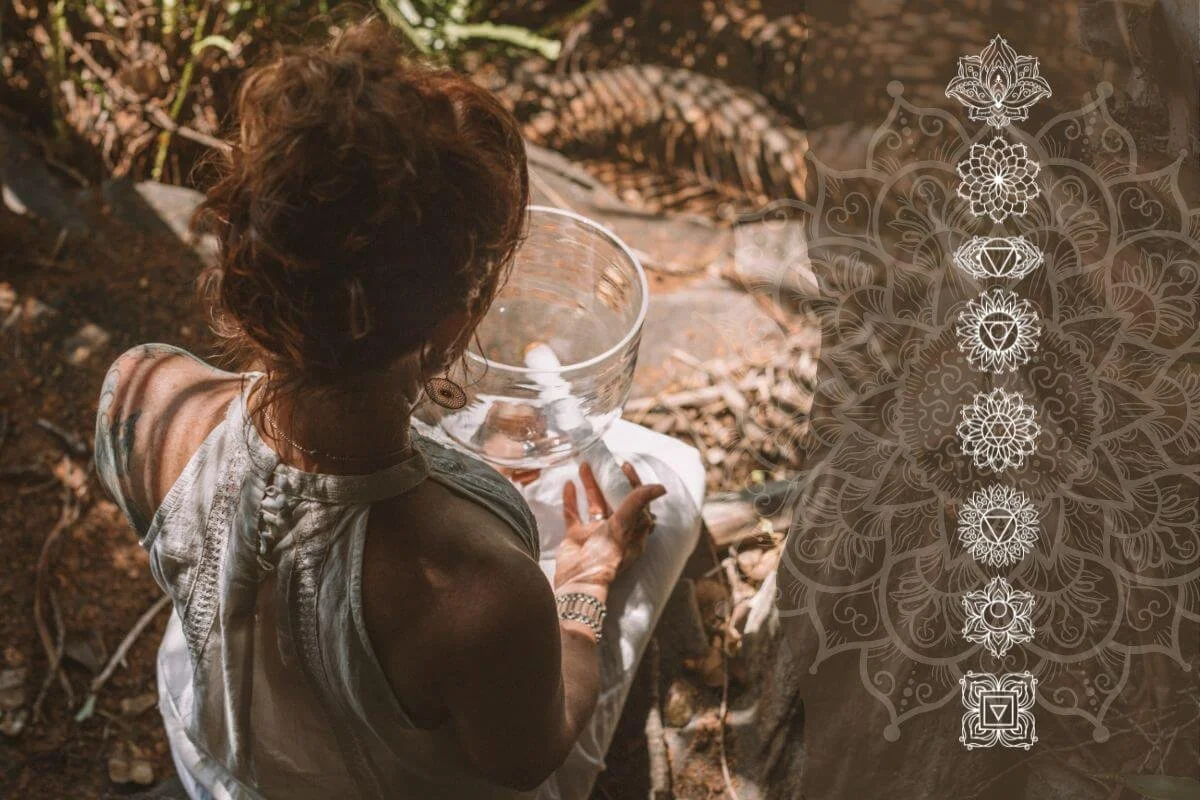 A woman in white clothing sits outdoors on tree roots, holding a crystal singing bowl. There is a decorative, intricate pattern overlay on the right side of the image.
