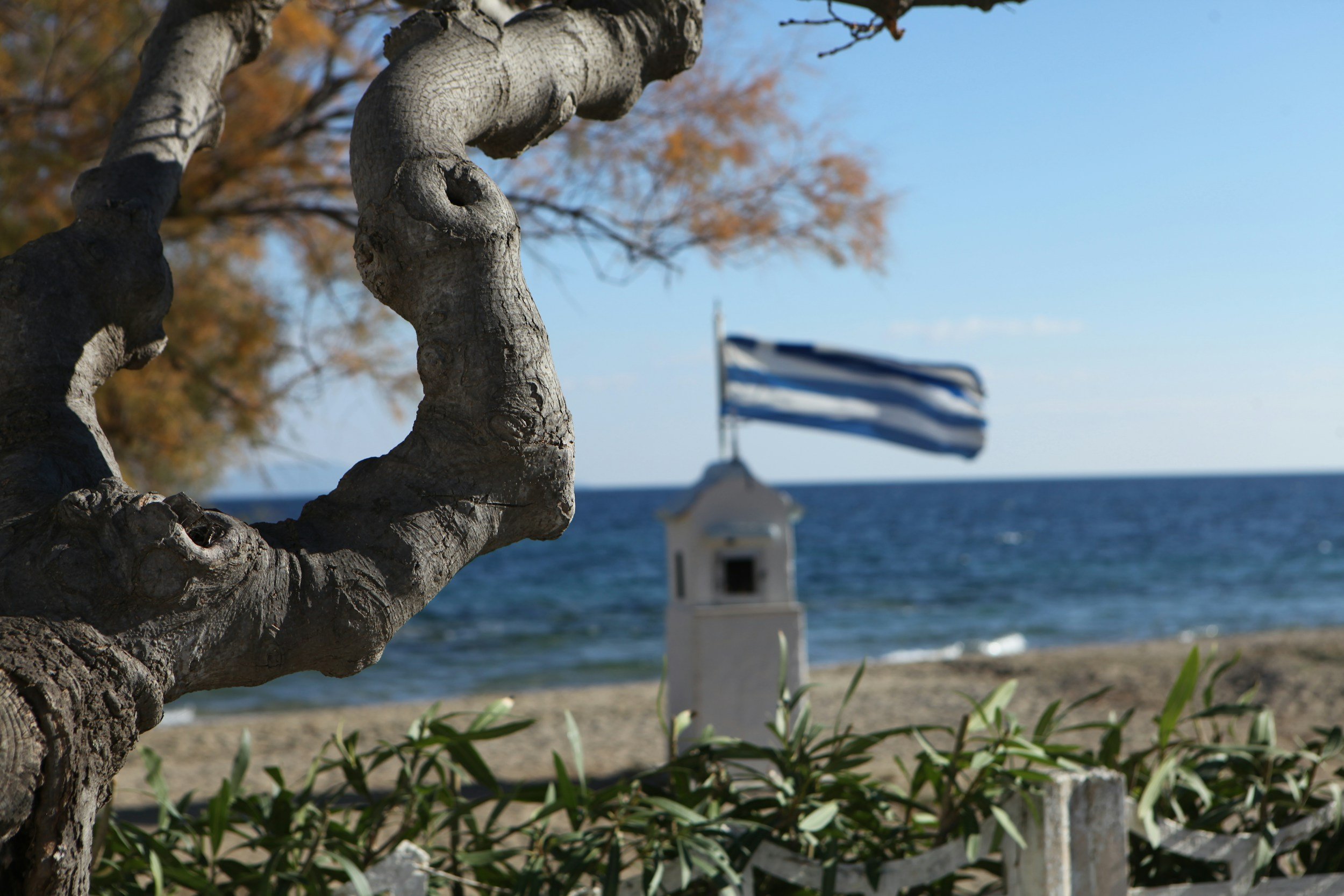 Greek flag and seaside chapel near Nea Makri Greece