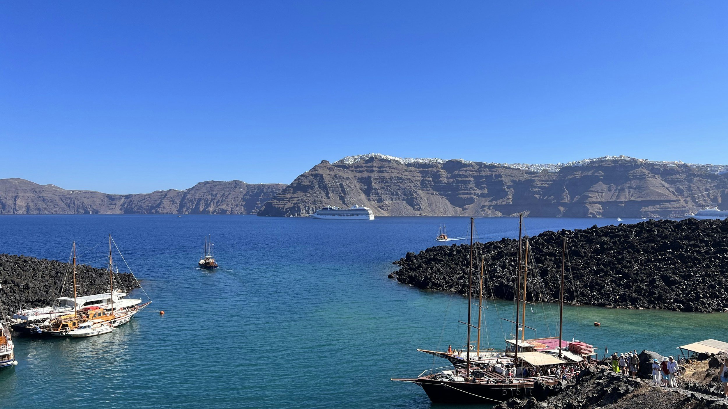 Santorini volcanic caldera and Hot Springs area viewed from the sea