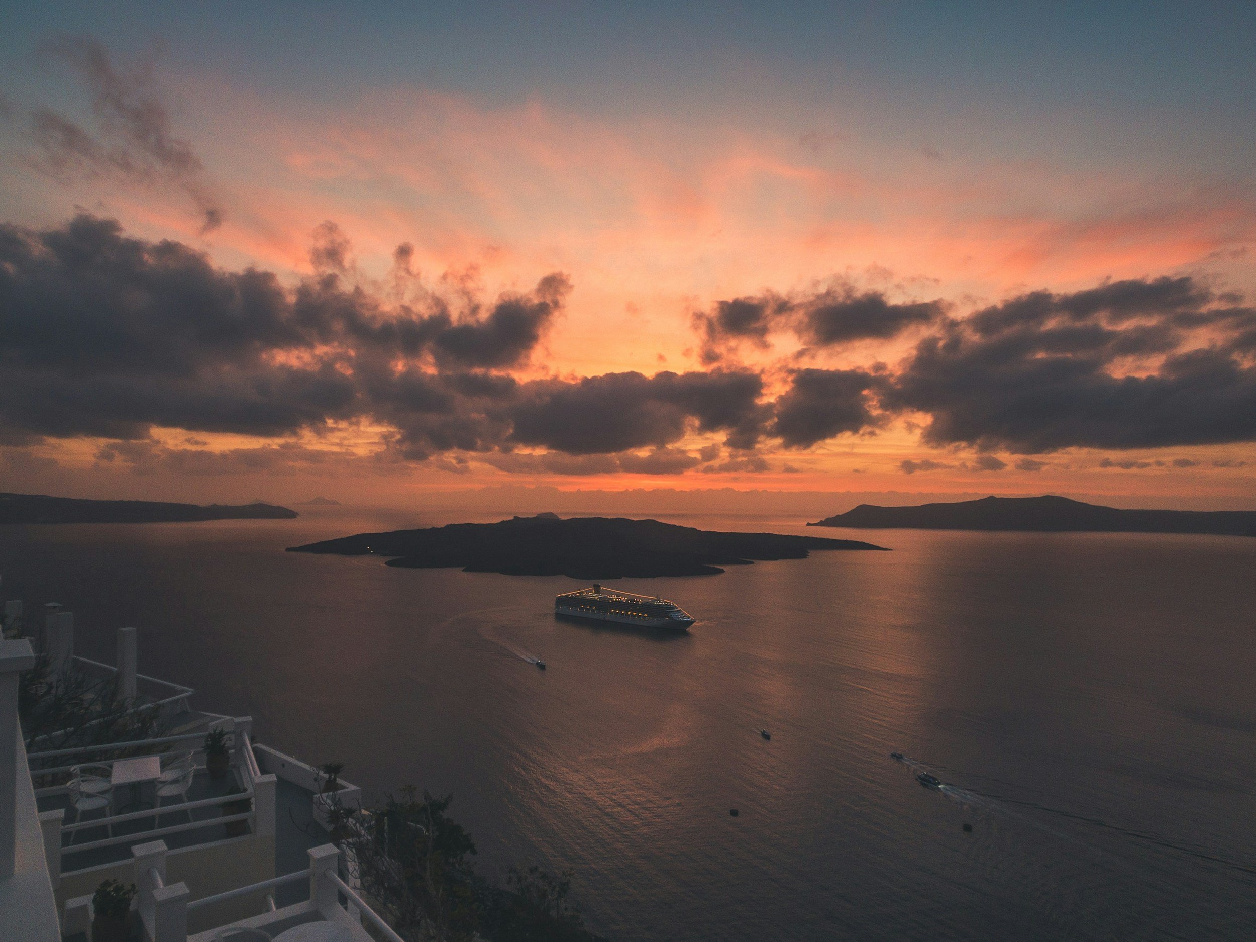 Santorini sunset catamaran cruise with caldera views from the sea