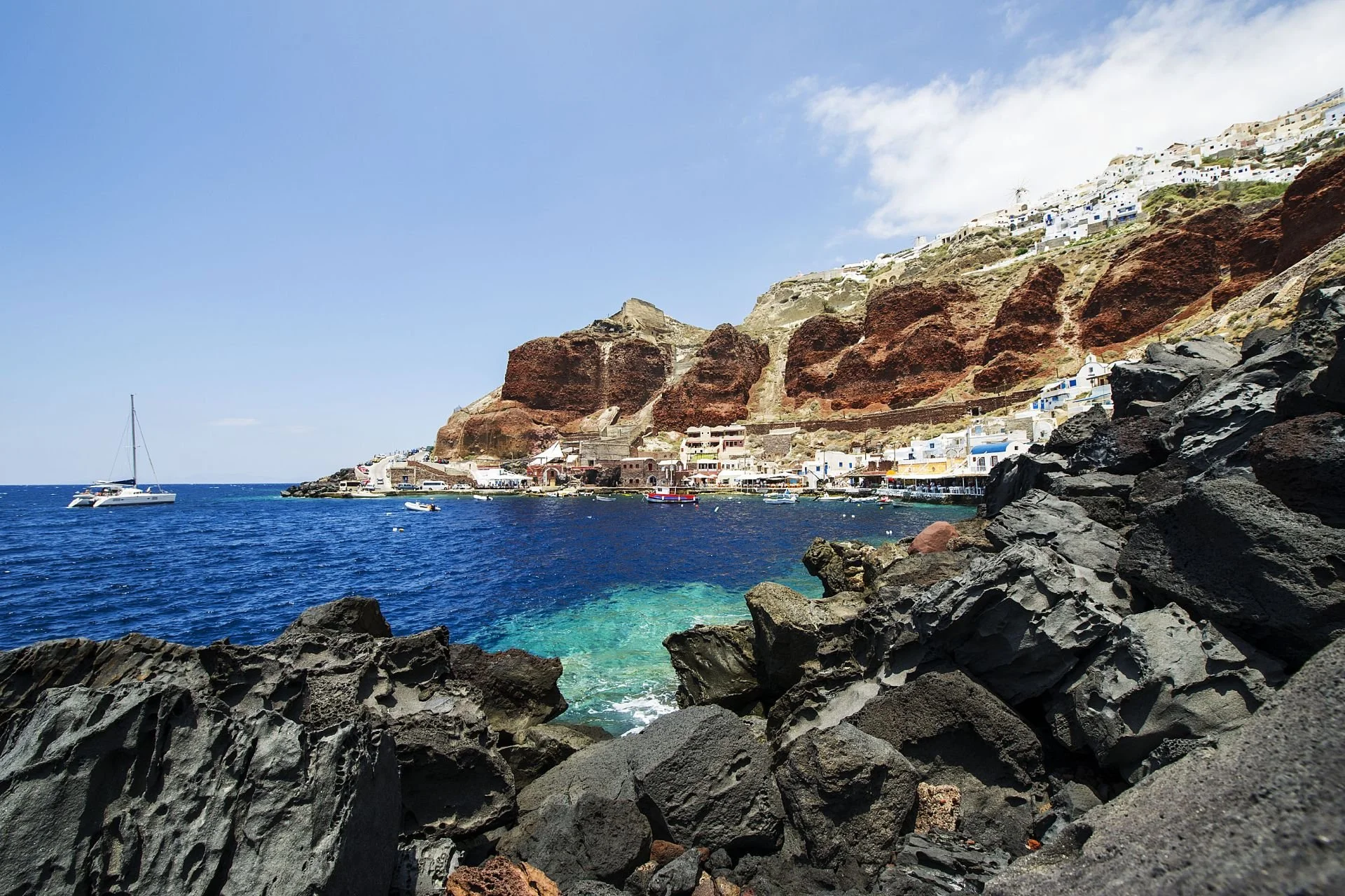 Ammoudi Bay and Oia cliffs viewed from Santorini catamaran cruise