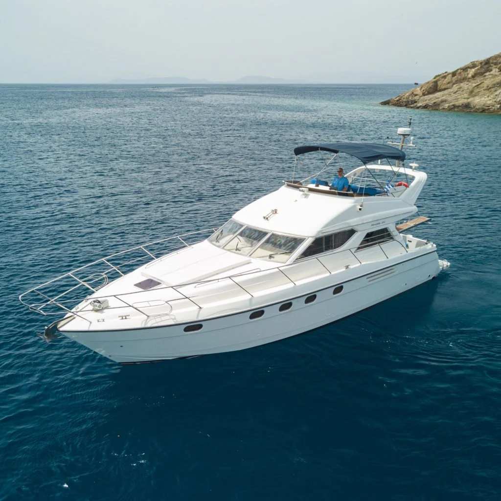 White motor yacht at sea for a flexible private cruise from Athens