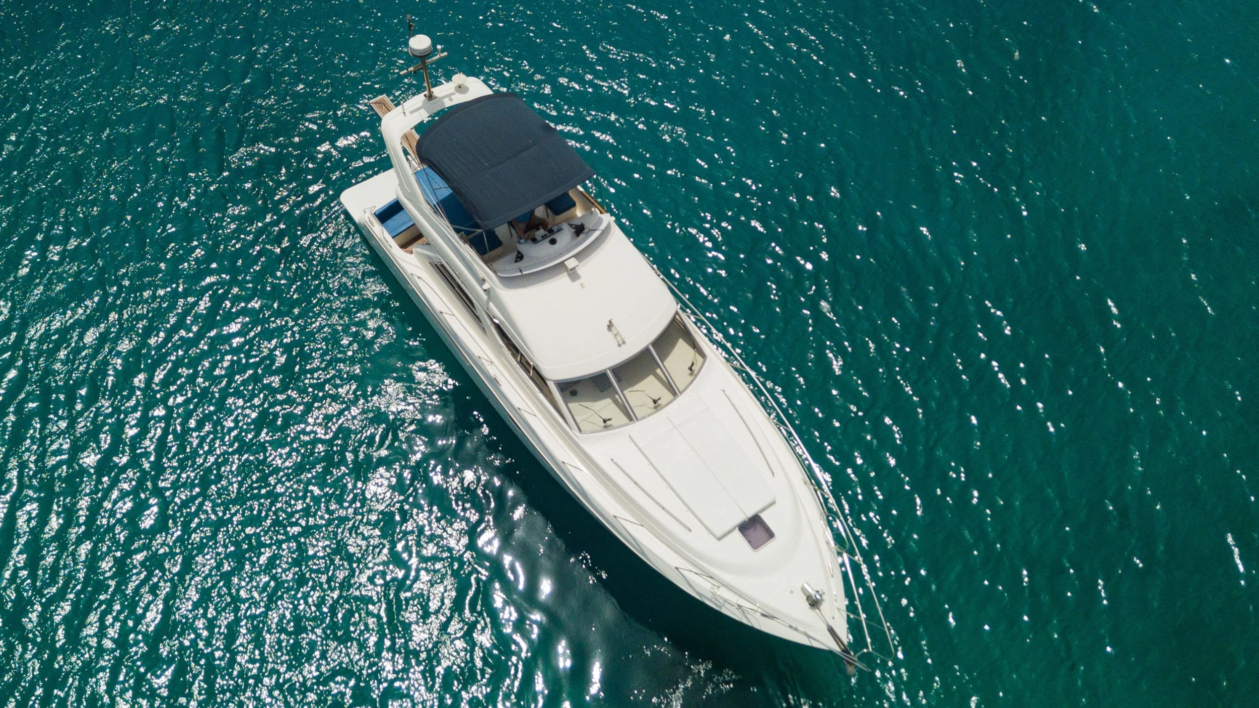 Private motor yacht cruising on turquoise waters near Athens