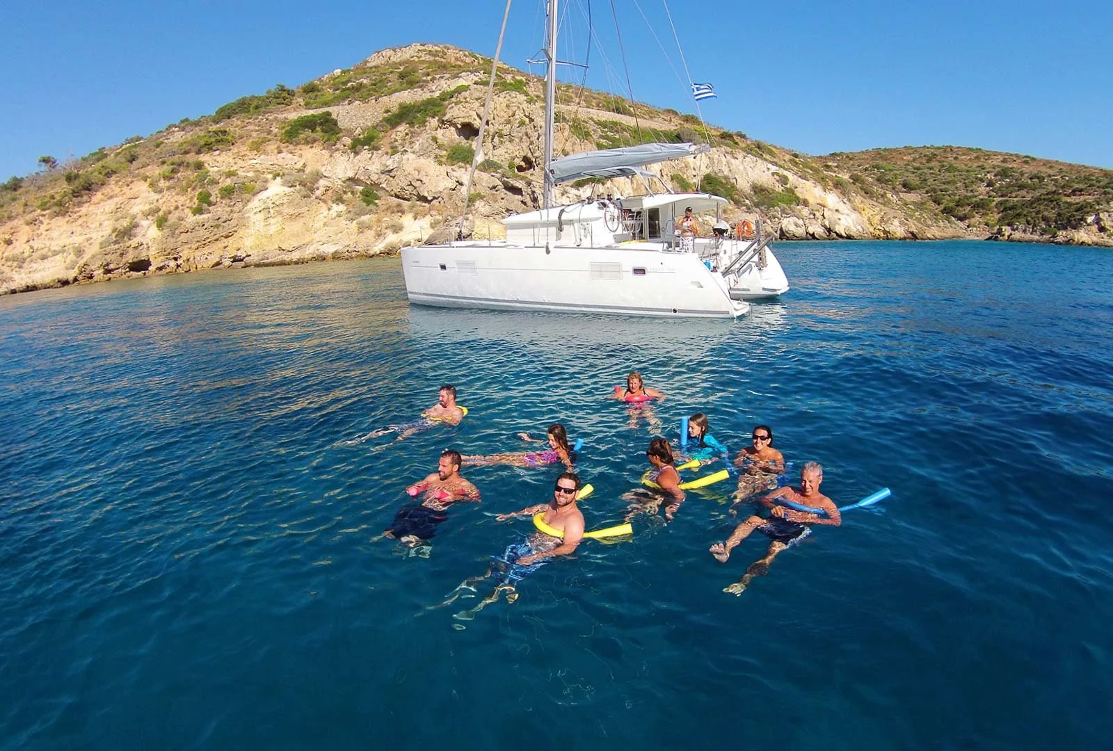 Guests swimming near a catamaran during a Hydrousa Island swim stop