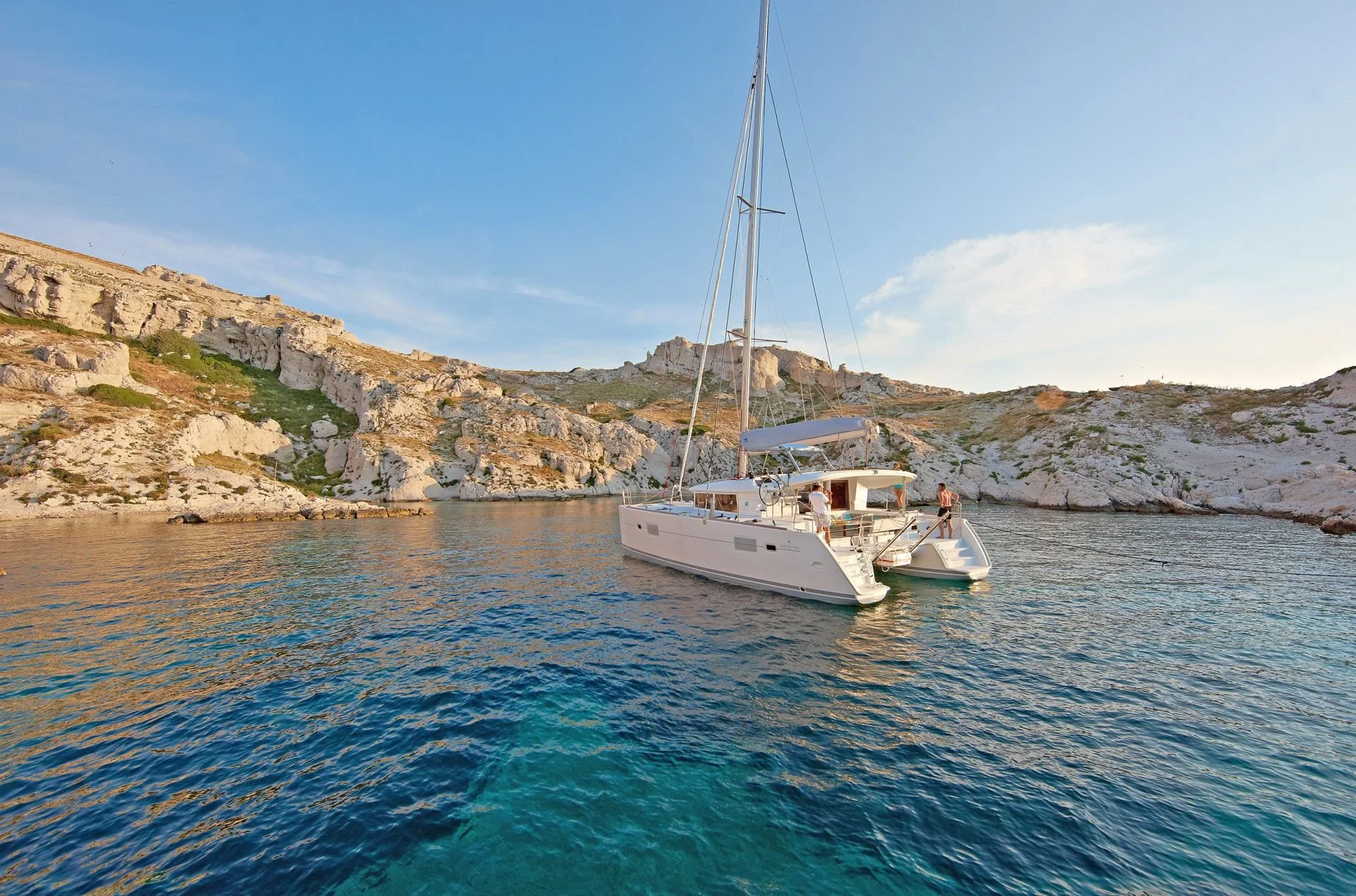 Catamaran anchored in turquoise waters near Mykonos during a full-day sailing cruise