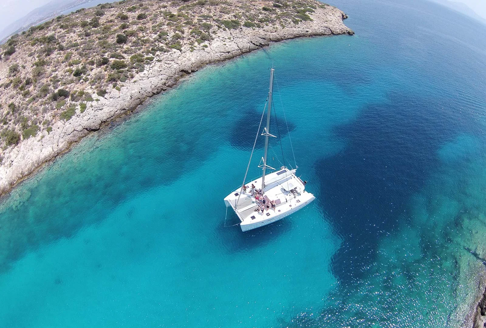 Private catamaran anchored in clear blue waters of the Saronic Gulf