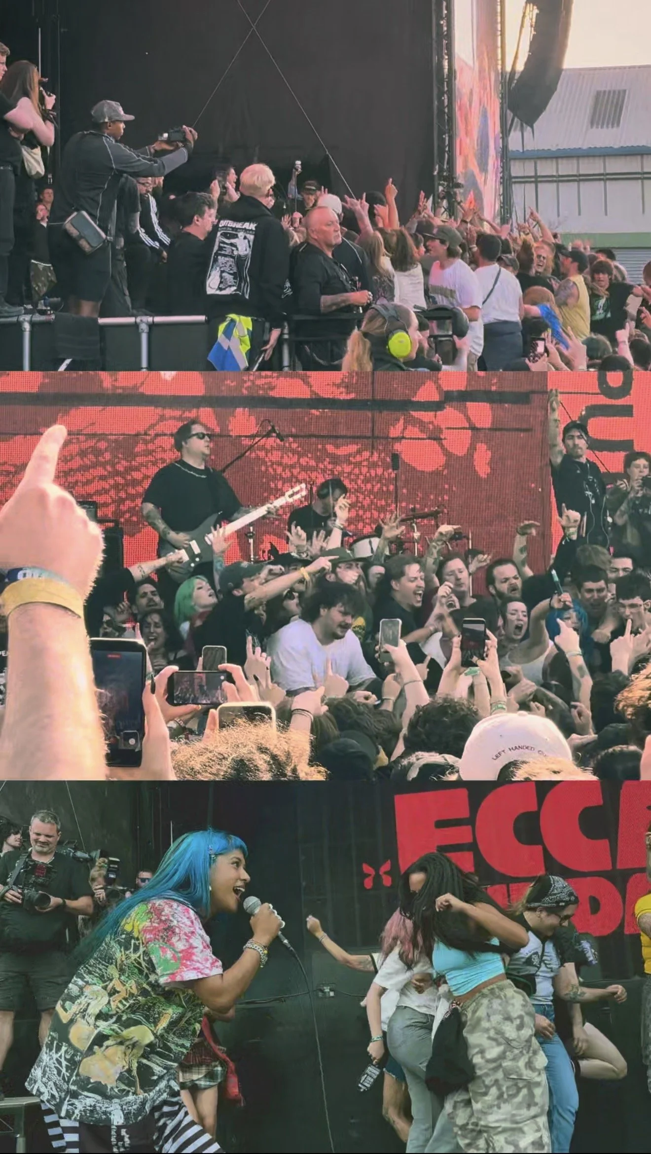 A crowd of people at a concert or music festival, with some taking photos and videos. The stage is visible in the background with performers and a large LED screen displaying red and black graphics. The audience is lively, with some dancing and engaging with the music.