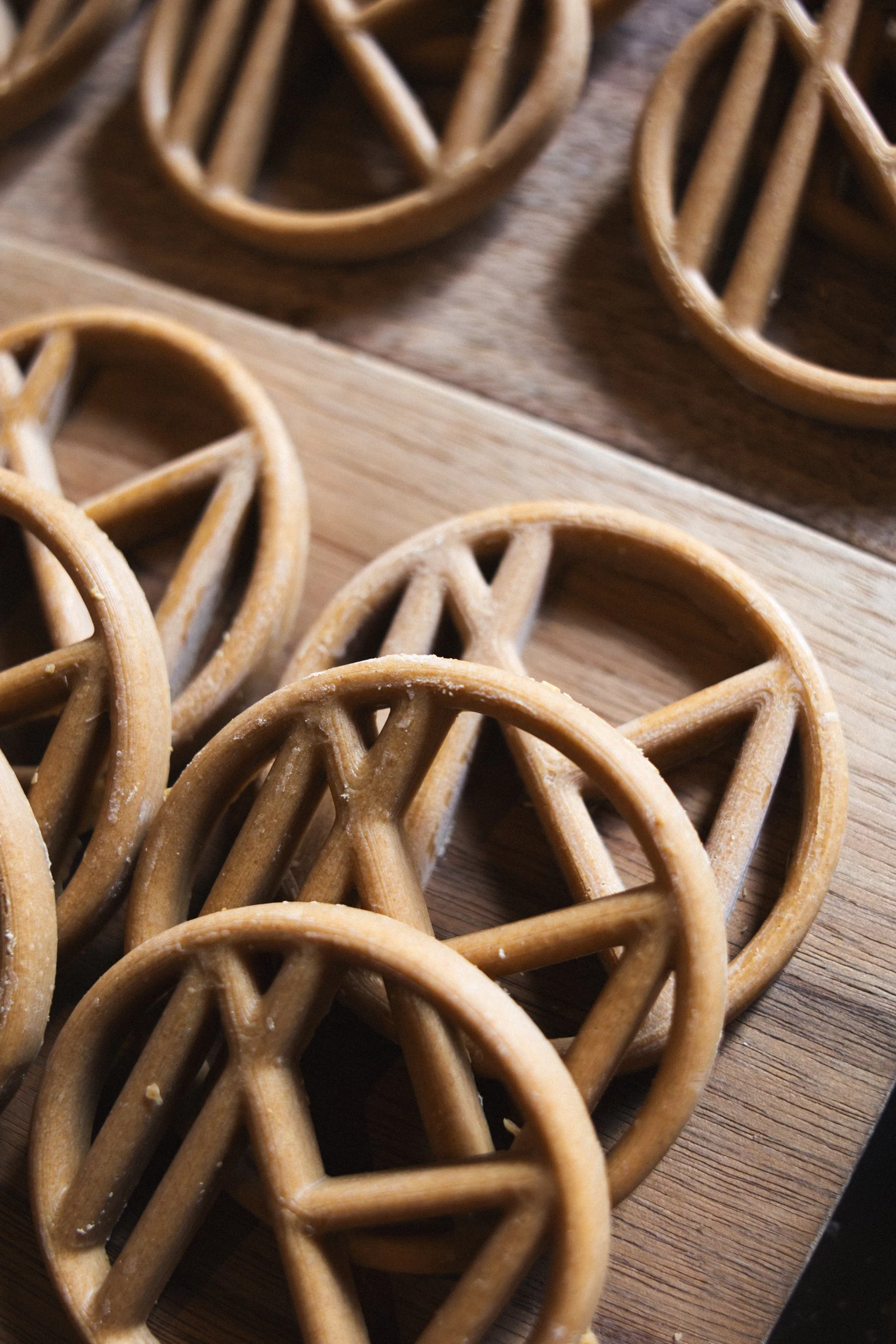 Close-up of several pretzels with a twisted knot shape on a wooden surface.