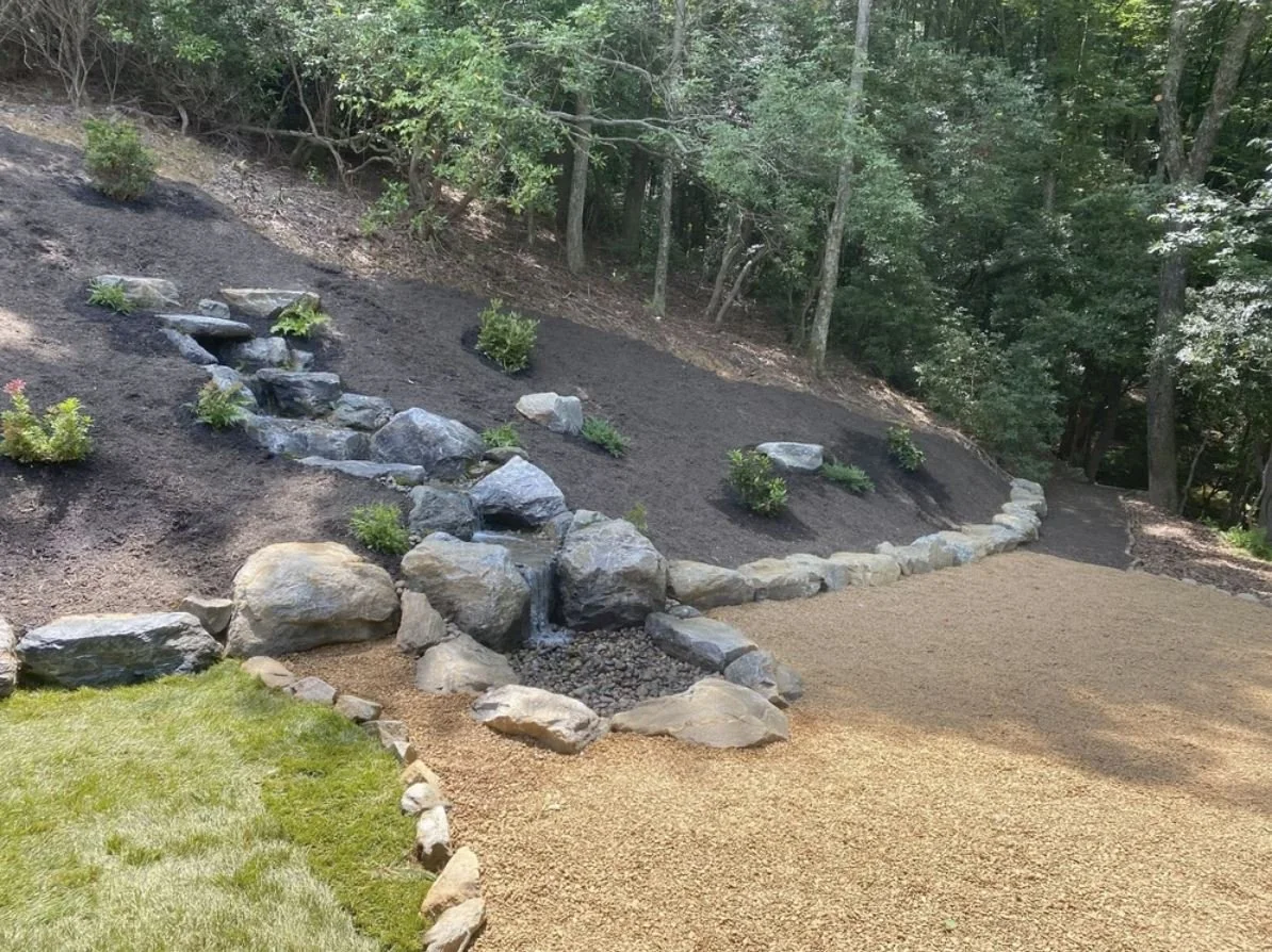 Early spring yard clean up in North Carolina with fresh mulch, trimmed shrubs, and cleared landscape beds