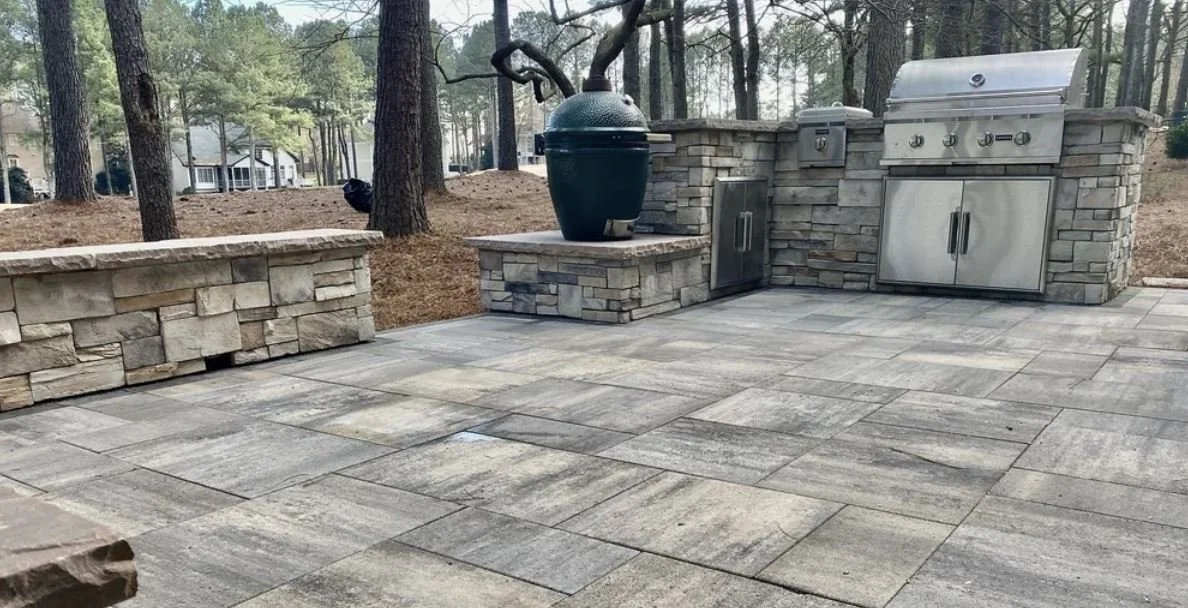 Outdoor living space with patio, fire pit, and seating area designed for a North Carolina backyard