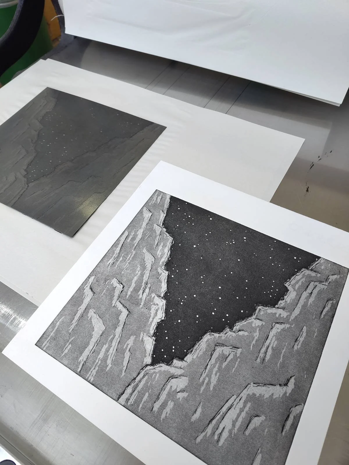 print of mountains with starry sky on a press with the plate