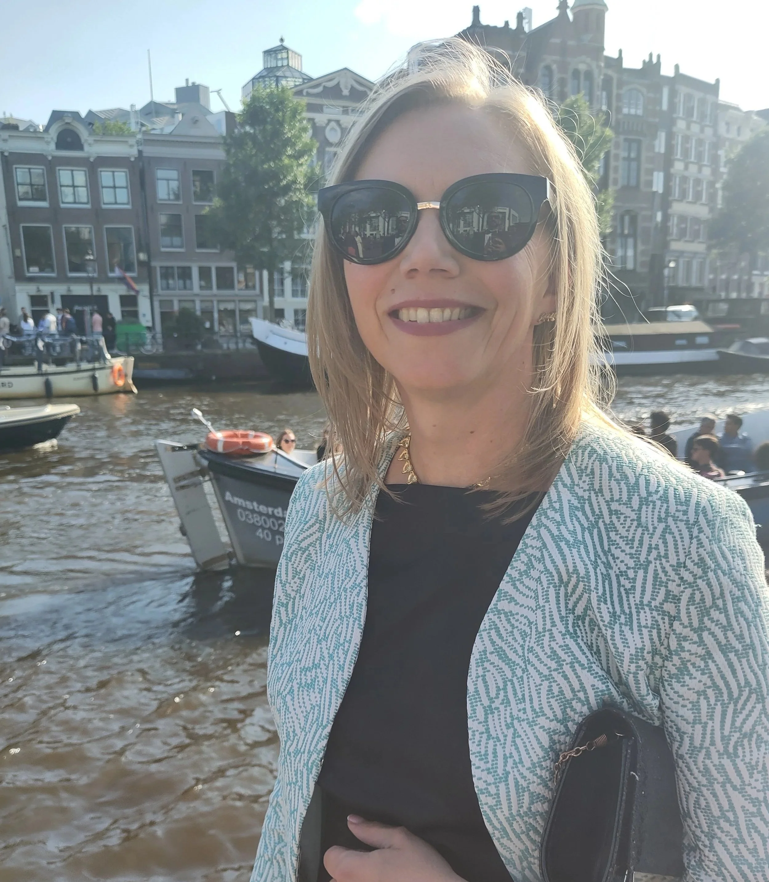 Sanna Sumner, qualified Nutritional Therapist, beside an Amsterdam canal