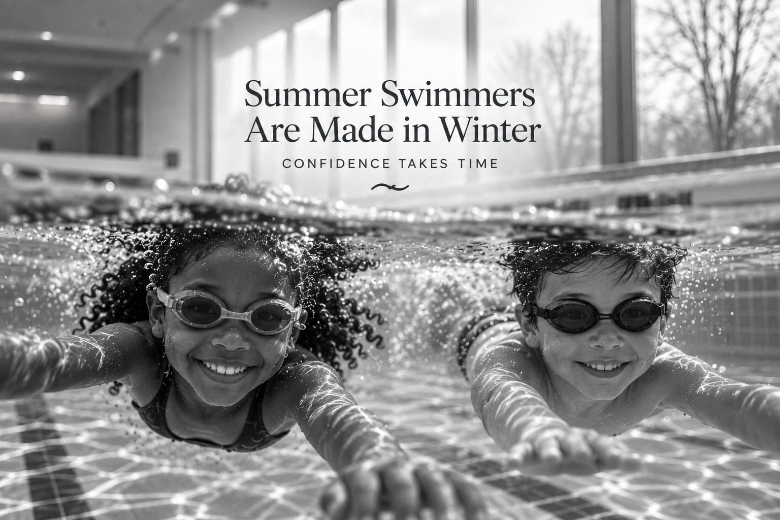 Two children swimming confidently indoors during winter