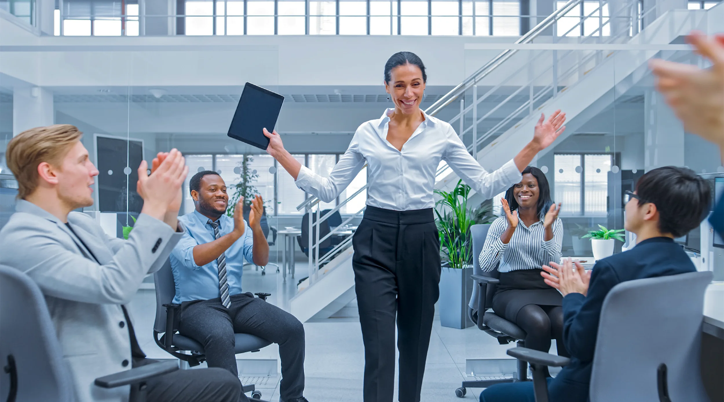 Manager leading a high-performing team, demonstrating how effective leadership and the right support help top employees scale their impact across the organization.