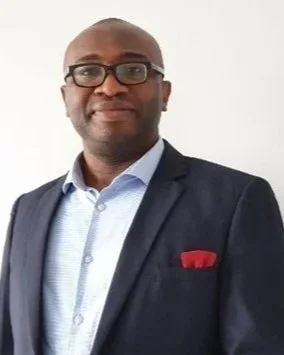 Man in a suit with glasses smiling