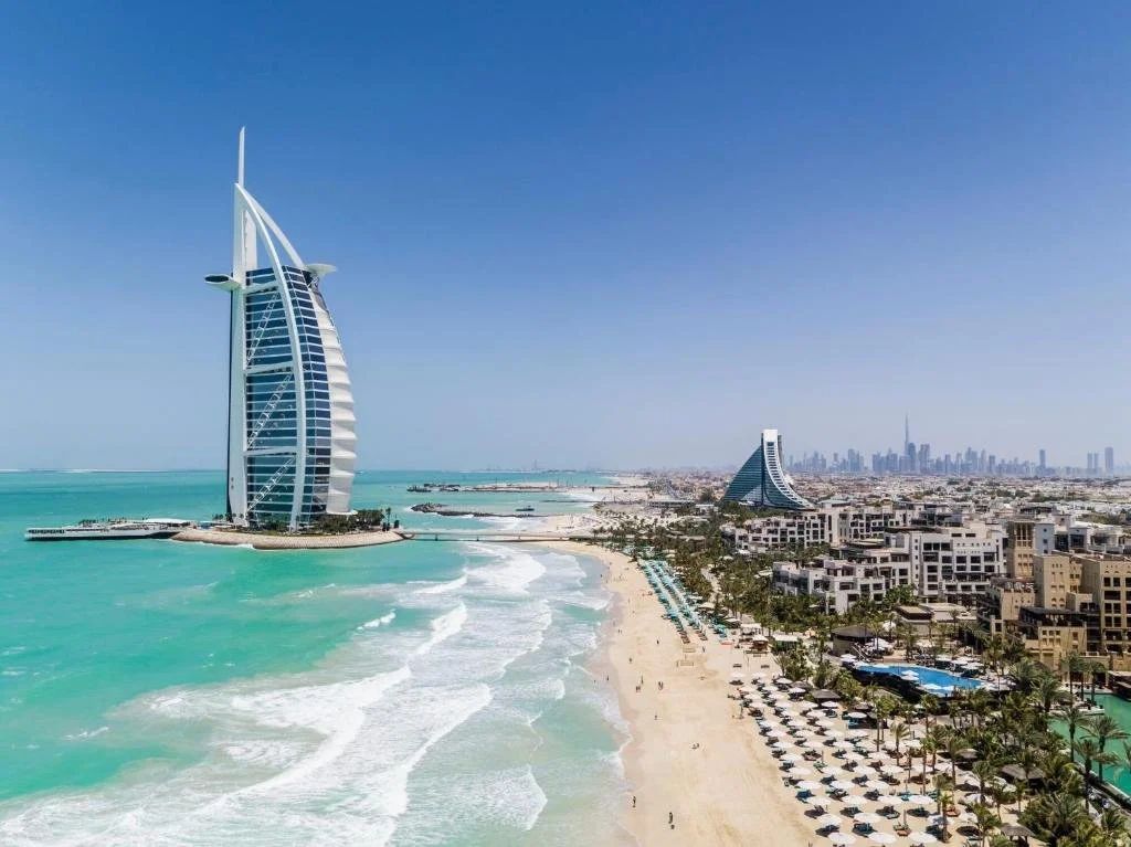 Skyline of Dubai with Burj Al Arab hotel, beach, and cityscape in background