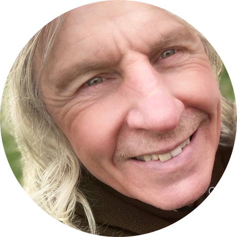 A close-up profile portrait of smiling sports performance hypnotist Barry Jones MSc.