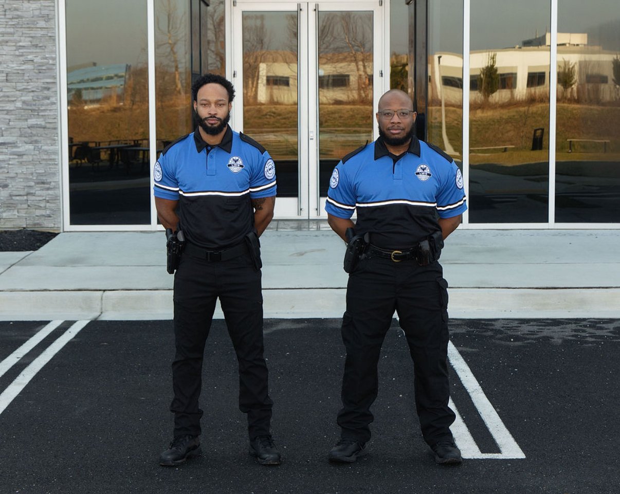 Last watch security team members standing side by side. Armed security guards