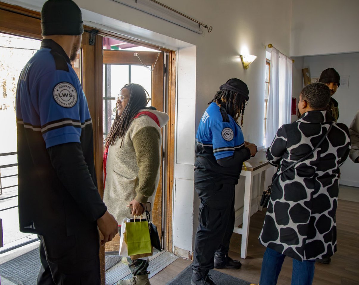 Security guards greeting guests at the door