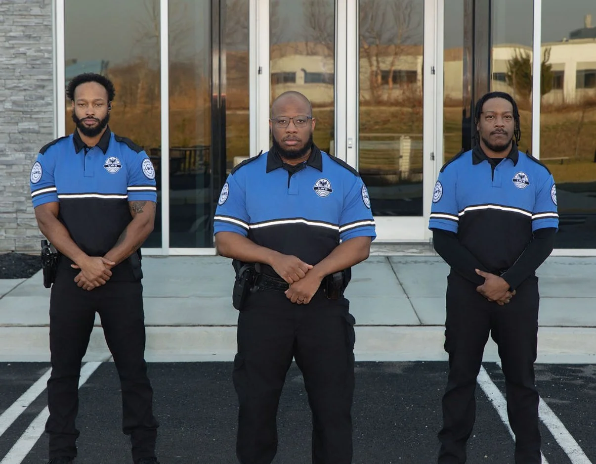 3 security guards standing side by side 