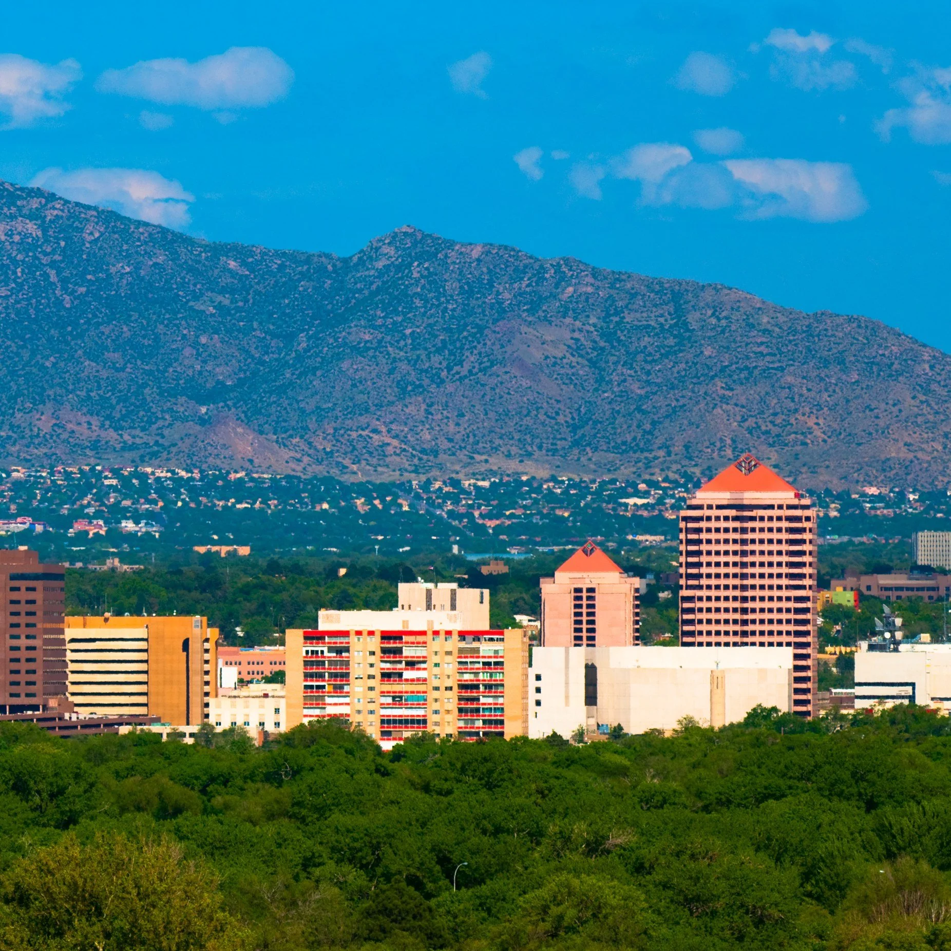 Downtown Albuquerque, New Mexico, with mountains rising behind the city.