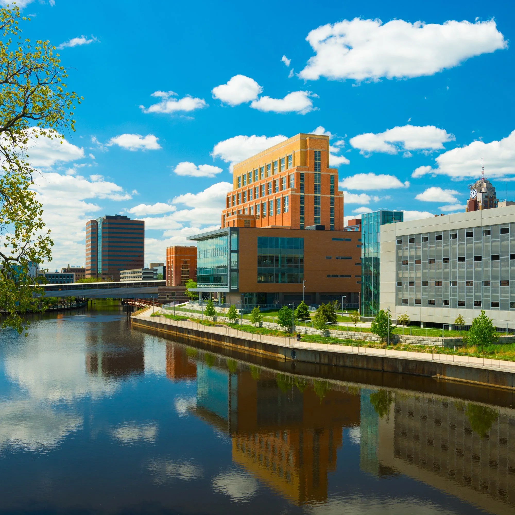 Downtown Lansing, Michigan, along the Grand River on a sunny day.