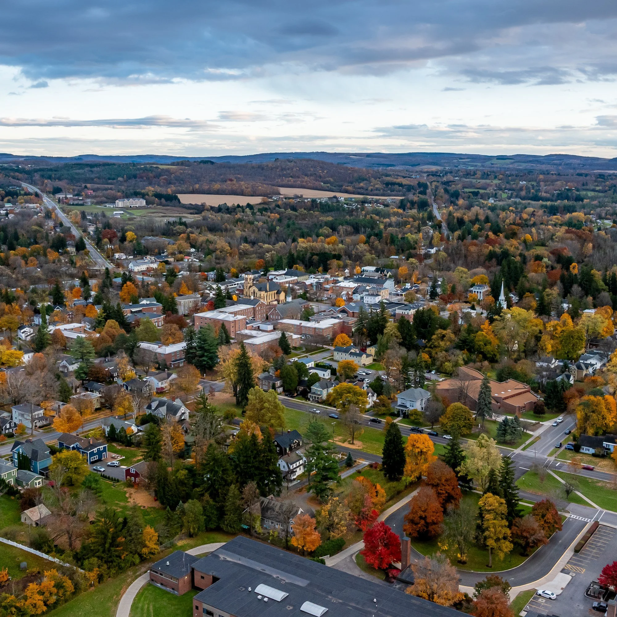 Aerial view of the village of Cazenovia, New York, surrounded by fall color.