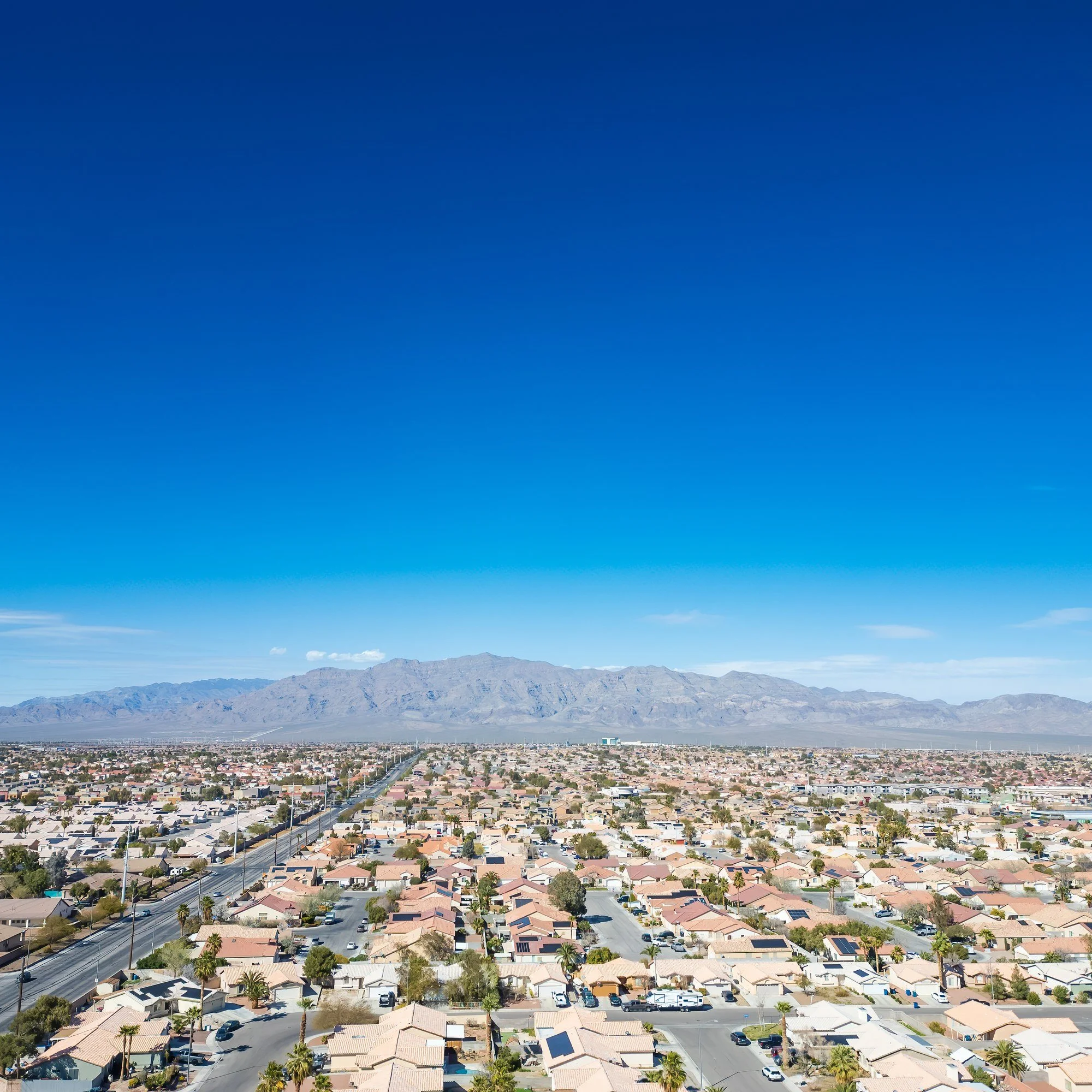 Aerial view of North Las Vegas, Nevada, with neighborhoods spreading toward the mountains.