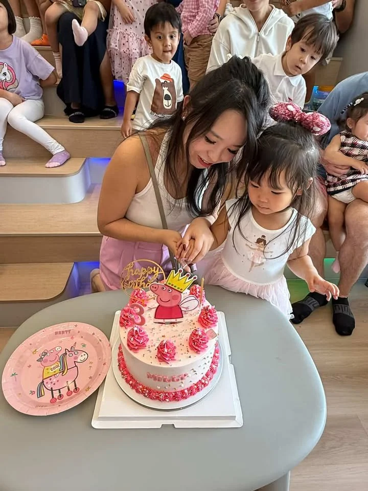 Mother and toddler cutting cake at the 3rd birthday celebration of a young girl held at Riri's Children Playloft at Upper Thomson. 