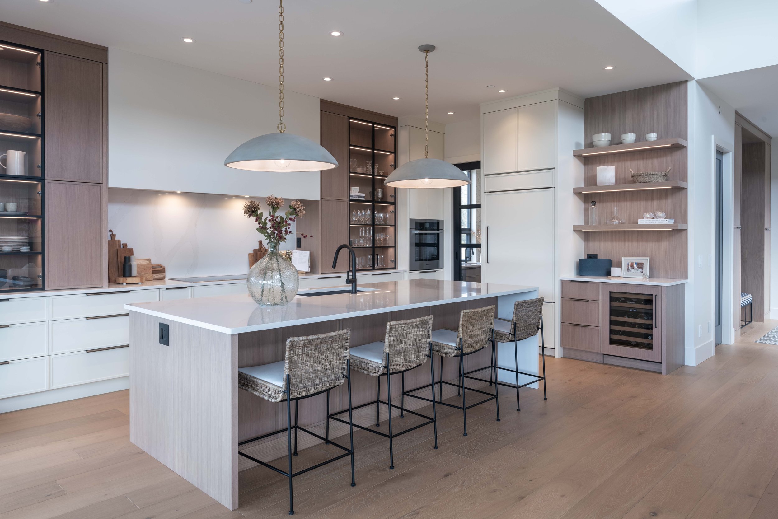 Modern kitchen with island, pendant lights, and built-in shelves