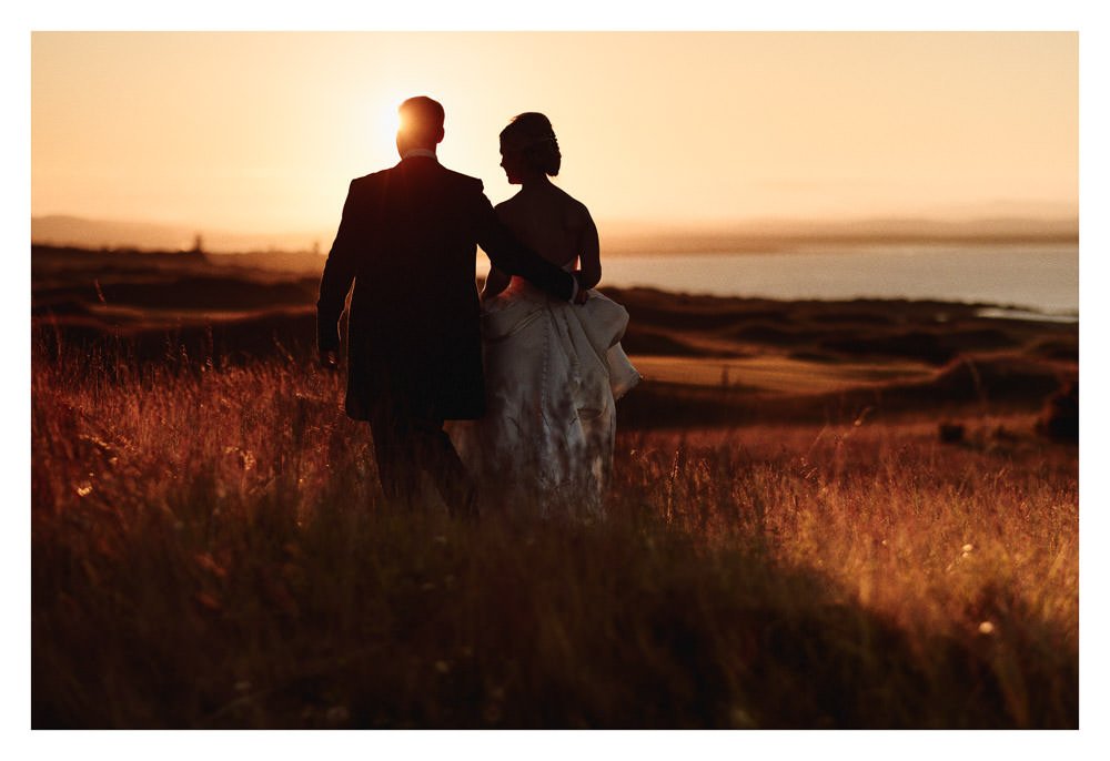 Stunning views at sunset of St Andrews Bay. wedding couple enjoying the atmosphere.