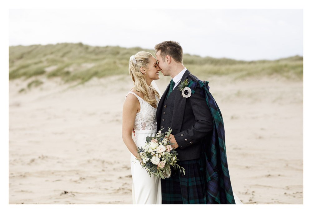Wedding couple enjoying their portraits in East Lothian.