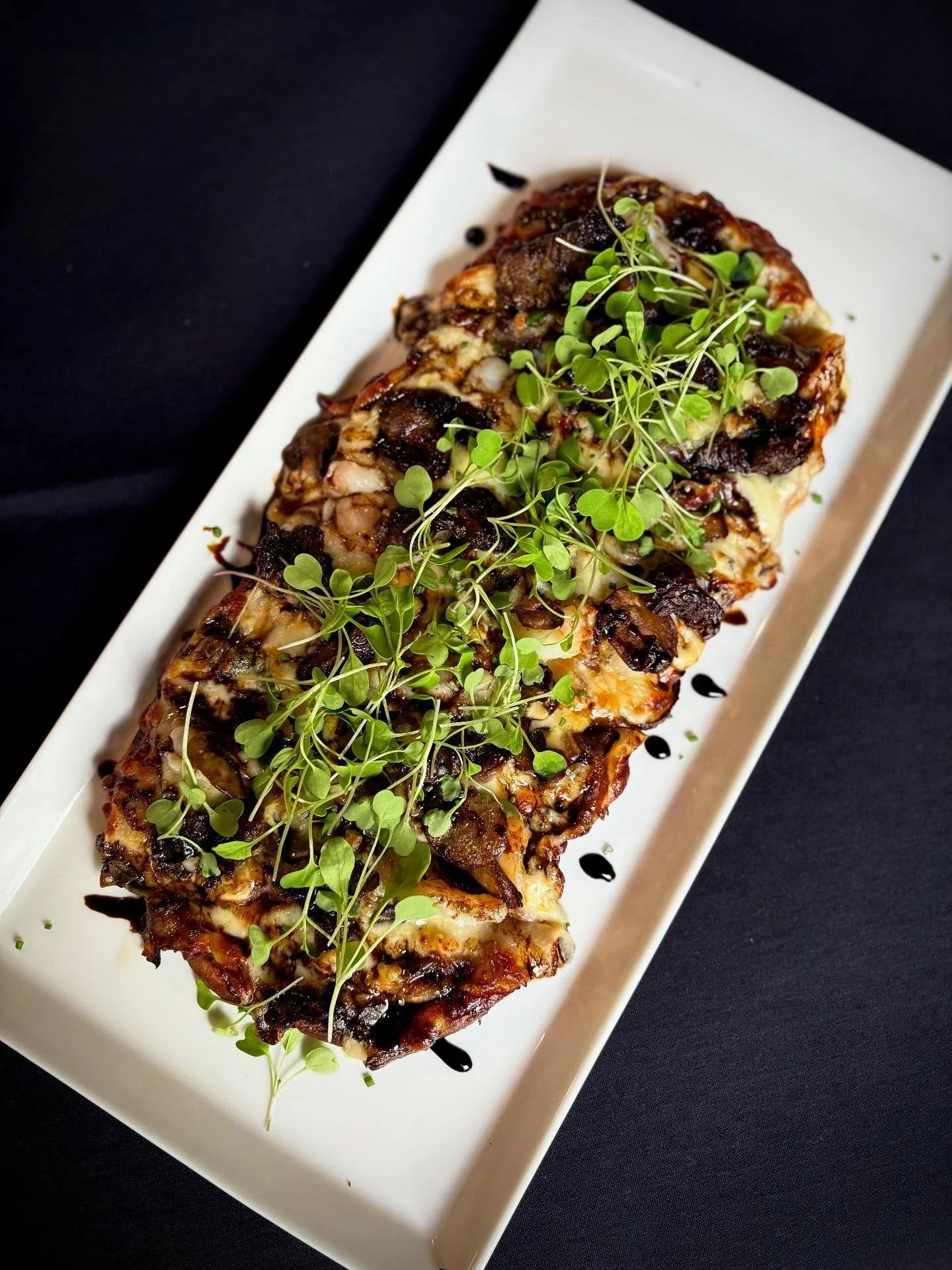 🔥Black &amp; Bleu Flatbread🔥
One of our weekend features crafted with love, by the INCREDIBLE Chef Ken!

This showstopper is loaded with 
Tender short rib 🥩 + juicy shrimp 🍤
A four-cheese meltdown 🧀🧀🧀🧀
Garlic aioli 🧄 + honey balsamic drizzle