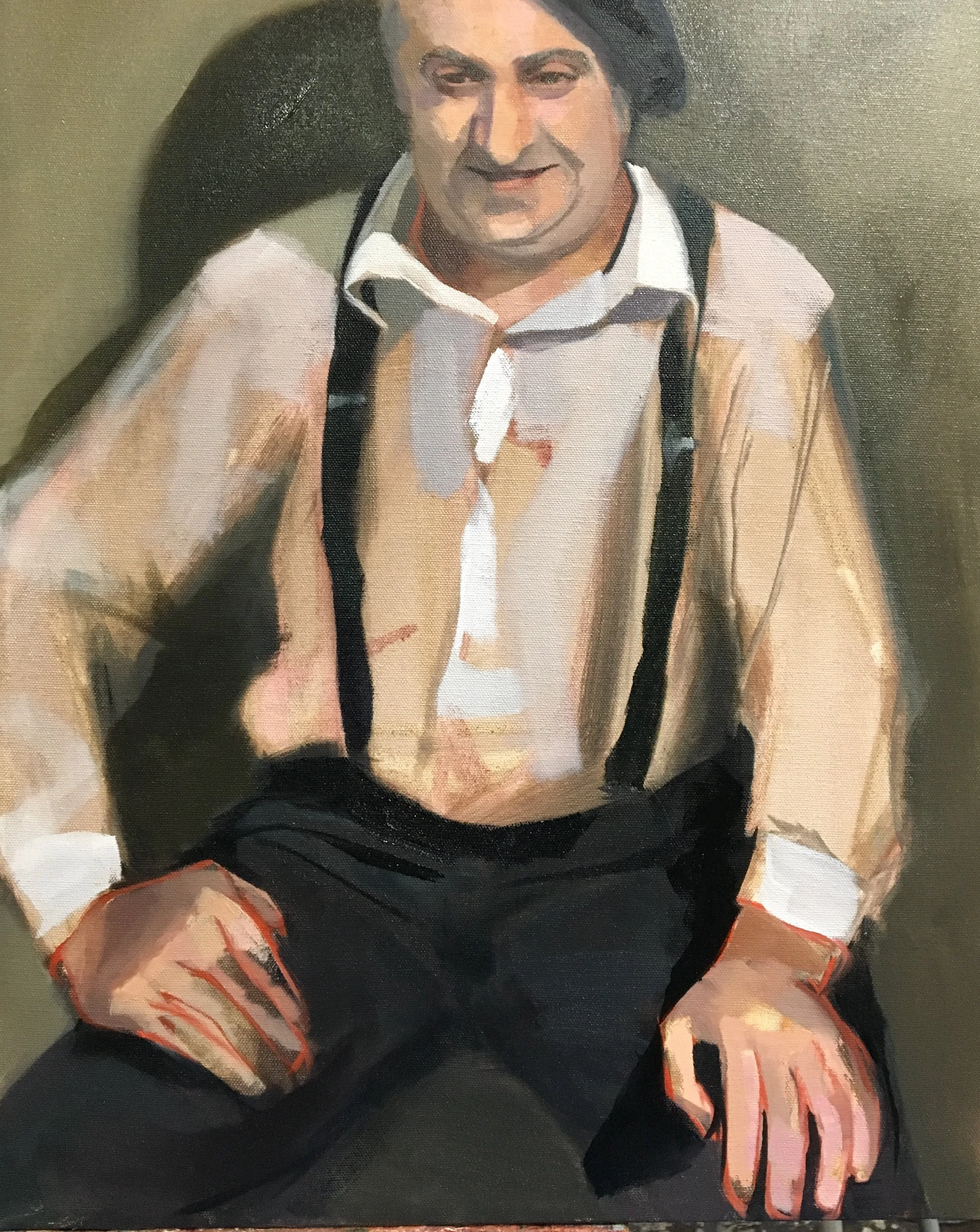 Portrait of Christophe, a french actor living in NYC. He is wearing a beret, white shirt, black suspenders, and black pants, sitting in an active pose and smiling with hands on his knees.