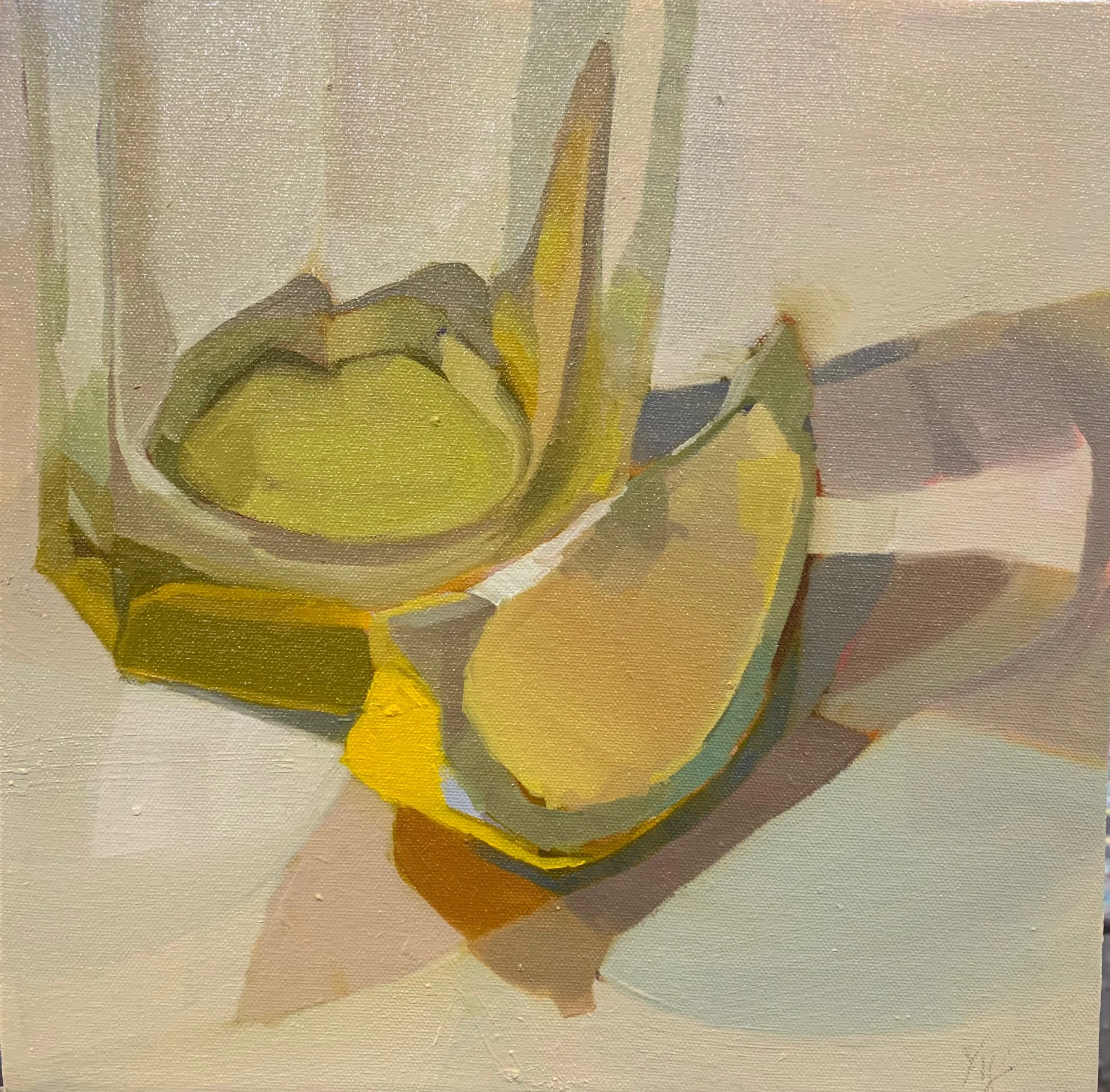Painting of a lemon wedge displaying its seed and flesh, with light shining through a glass and the lemon wedge to cast variations of yellow infused shadows on the surface.