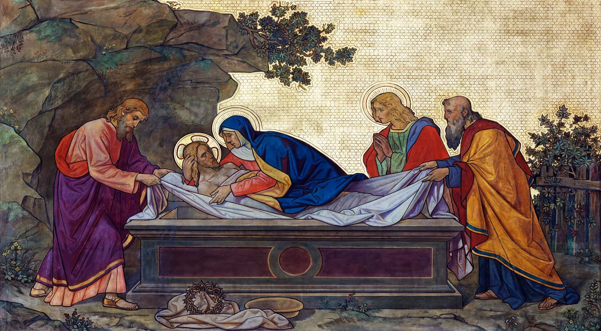 A religious scene of Jesus Christ being laid in the tomb, surrounded by four figures with halos.