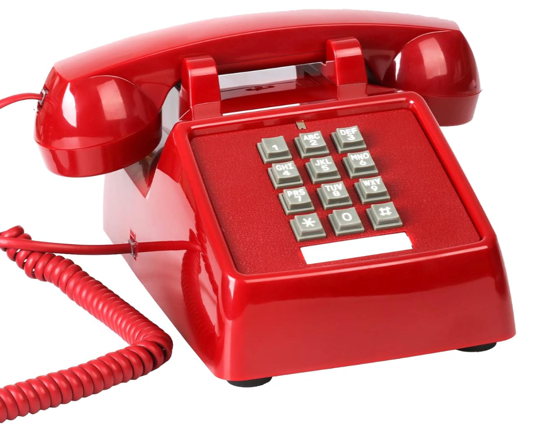 Red vintage rotary phone with a cord and keypad.