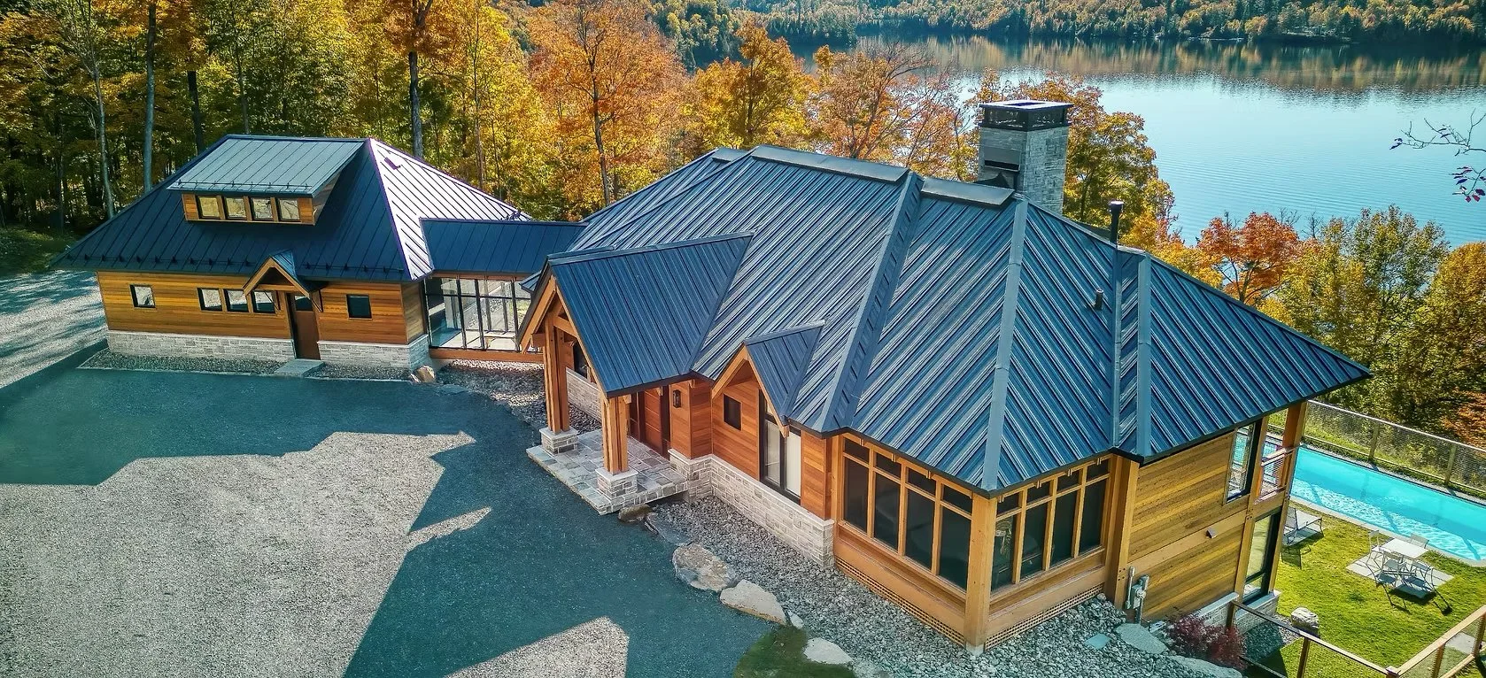 Norexco Construction, luxury home builder in Mont-Tremblant, showcasing craftsmanship and design with a modern chalet surrounded by nature.