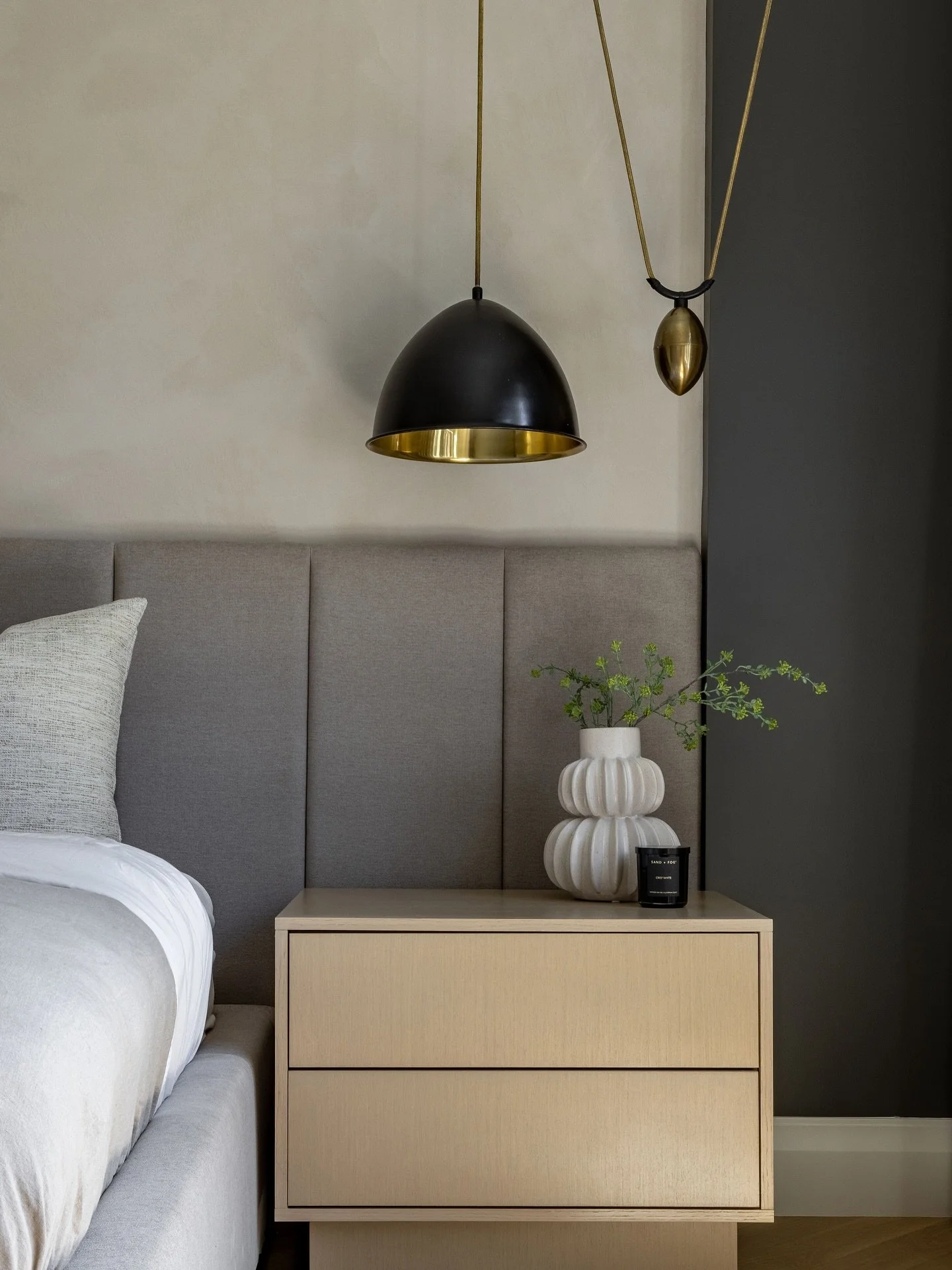 This primary bedroom features a plaster-finished wall that sets a soft, textural backdrop for the wall-to-wall headboard and custom nightstands. And those statement pendant lights? They&rsquo;re the perfect finishing touch.

Interior designer: @centr