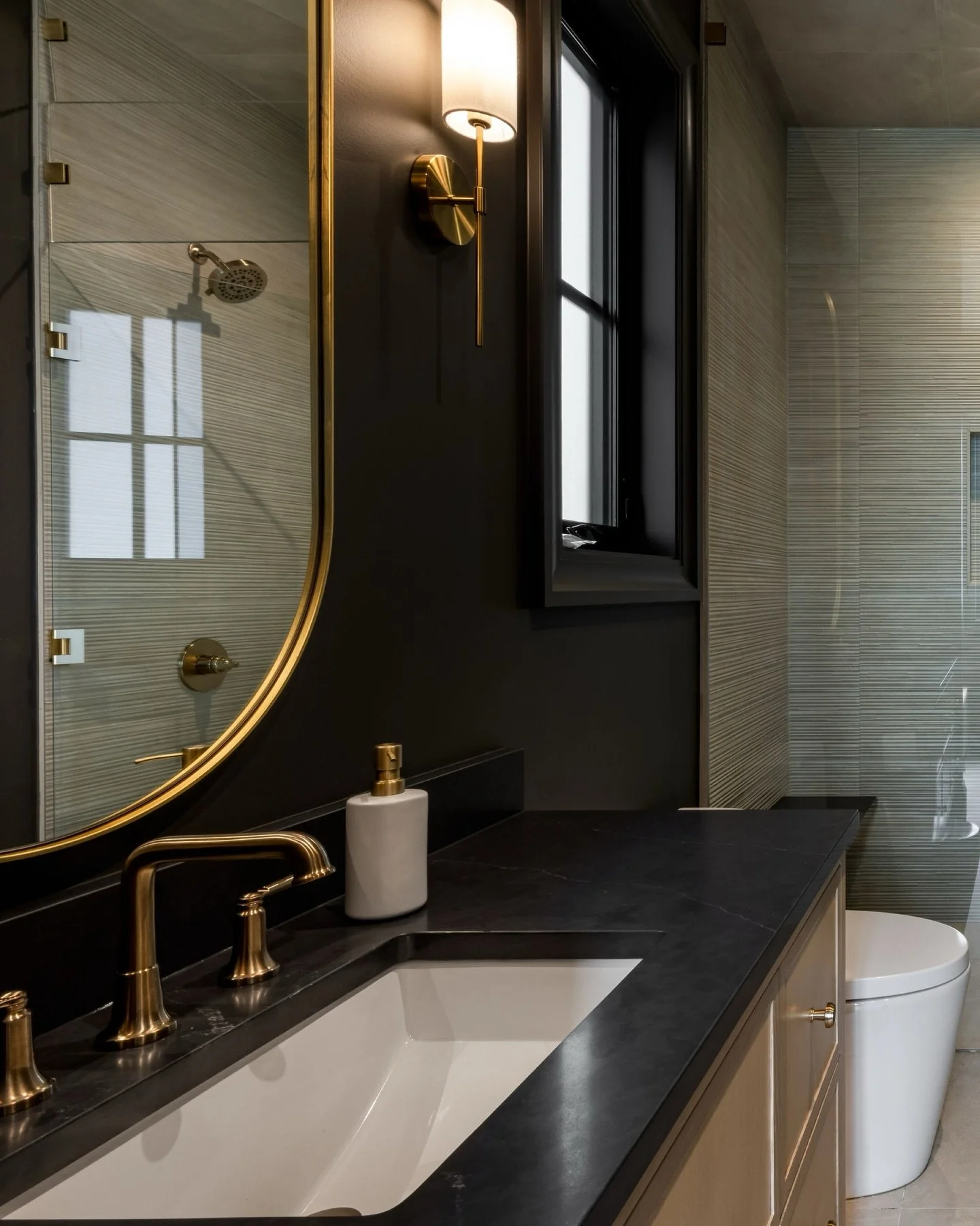 Who says bathroom walls need to be light and airy? We leaned into deeper tones and richer finishes to bring a little intensity to this moody gym bathroom 🖤

Interior Designer: @centrestagedesign 
Photographer: @ana__zaha 
Builder: @alphawesthomes 
.