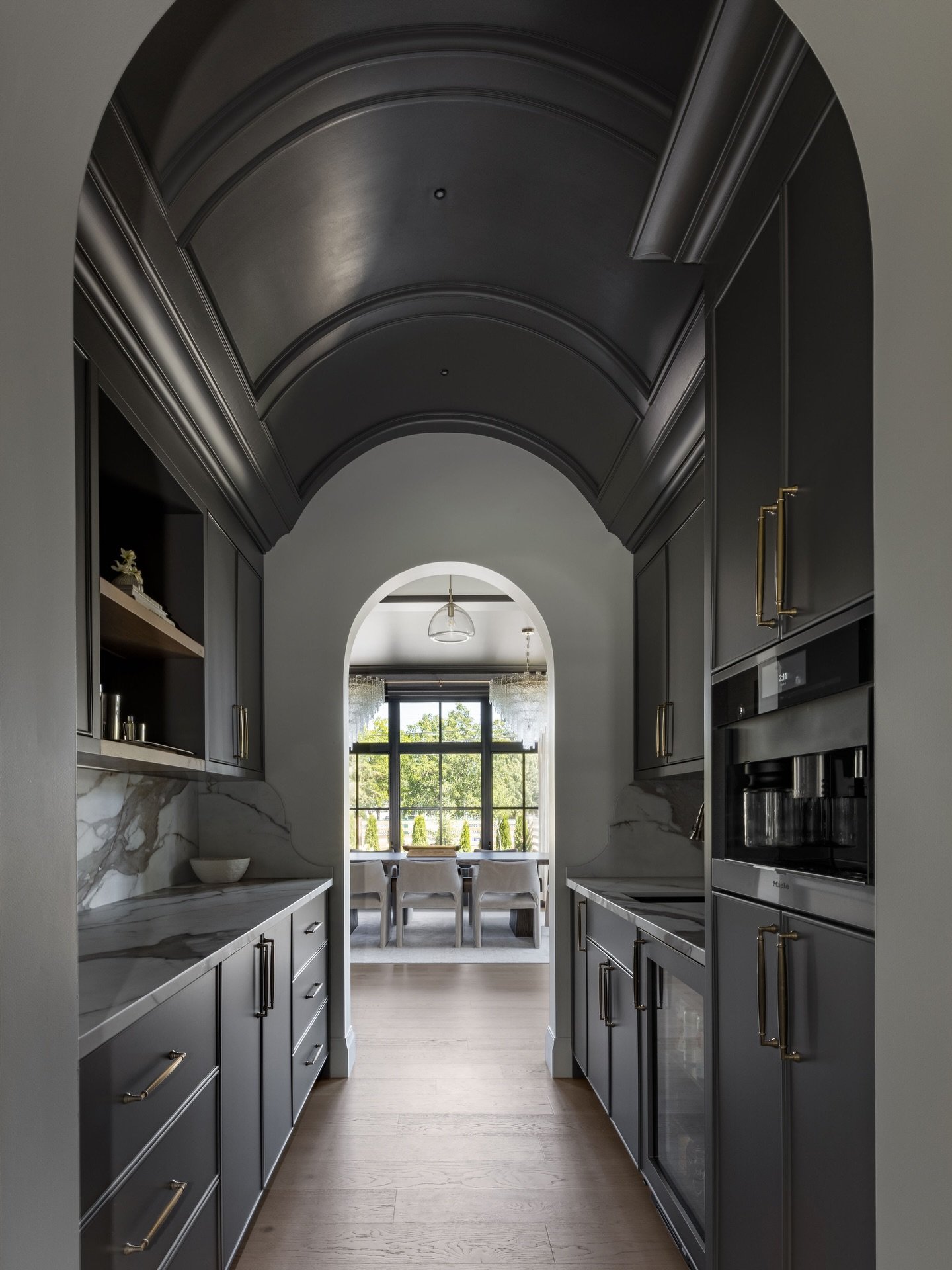 Imagine walking from the kitchen into the dining room and passing through this stunning coffee &amp; wine bar.
The high-gloss barrelled ceiling flows seamlessly into the cabinetry, creating a moment that truly stops you in your tracks. Take a closer 