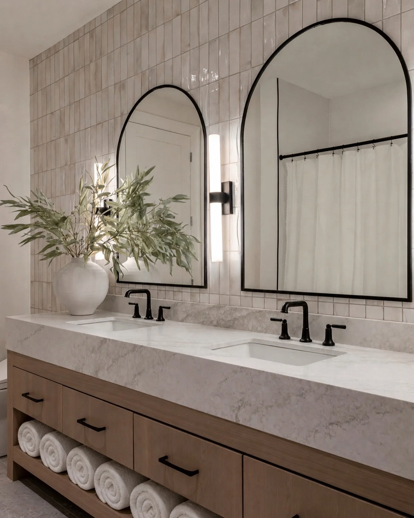 Pro tip! If you want your space to feel larger and more elevated, don&rsquo;t leave the wall behind your vanity blank. Adding tile behind the mirrors instantly draws the eye upward, creates height, and makes such a beautiful impact in the overall des