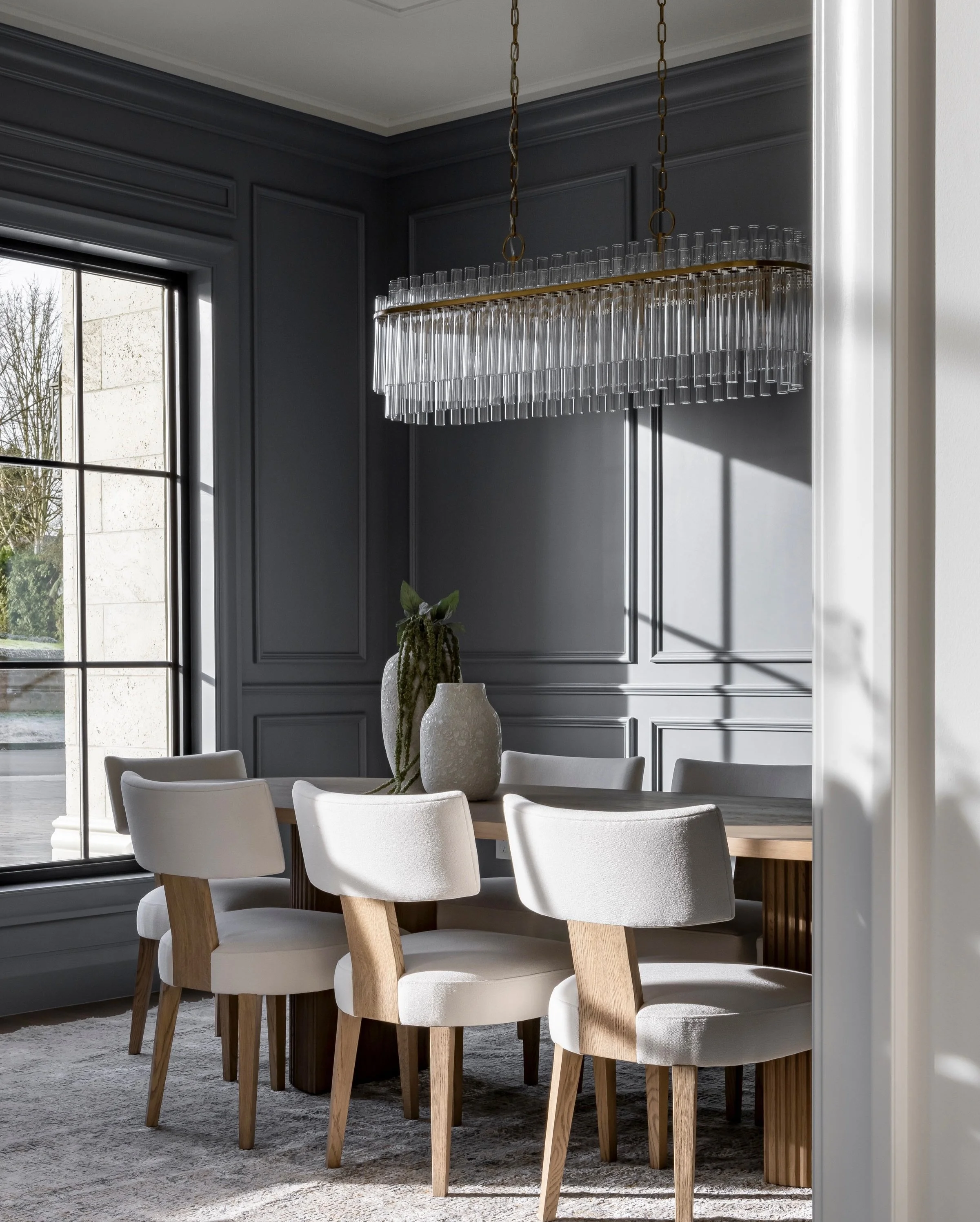 There&rsquo;s a sophisticated simplicity to this dining room that makes it feel truly timeless. Nothing competes for attention, yet every element carries its own presence. From the muted palette and tailored panel moulding to the sculptural lighting 