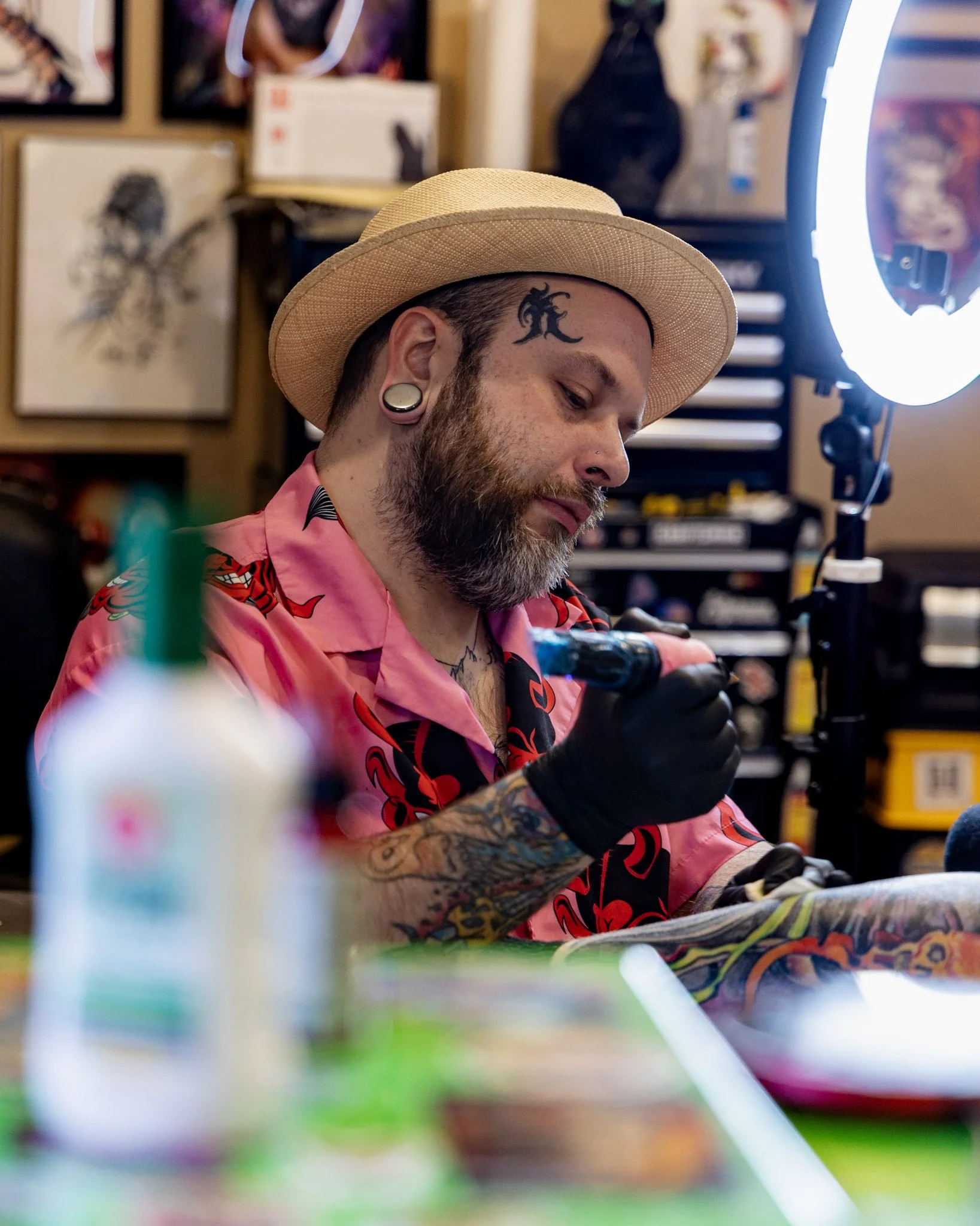 I picture of a male tattoo artist creating an amazing leg sleeve.  This tattoo is representing the client's love of Dungeons and Dragons.