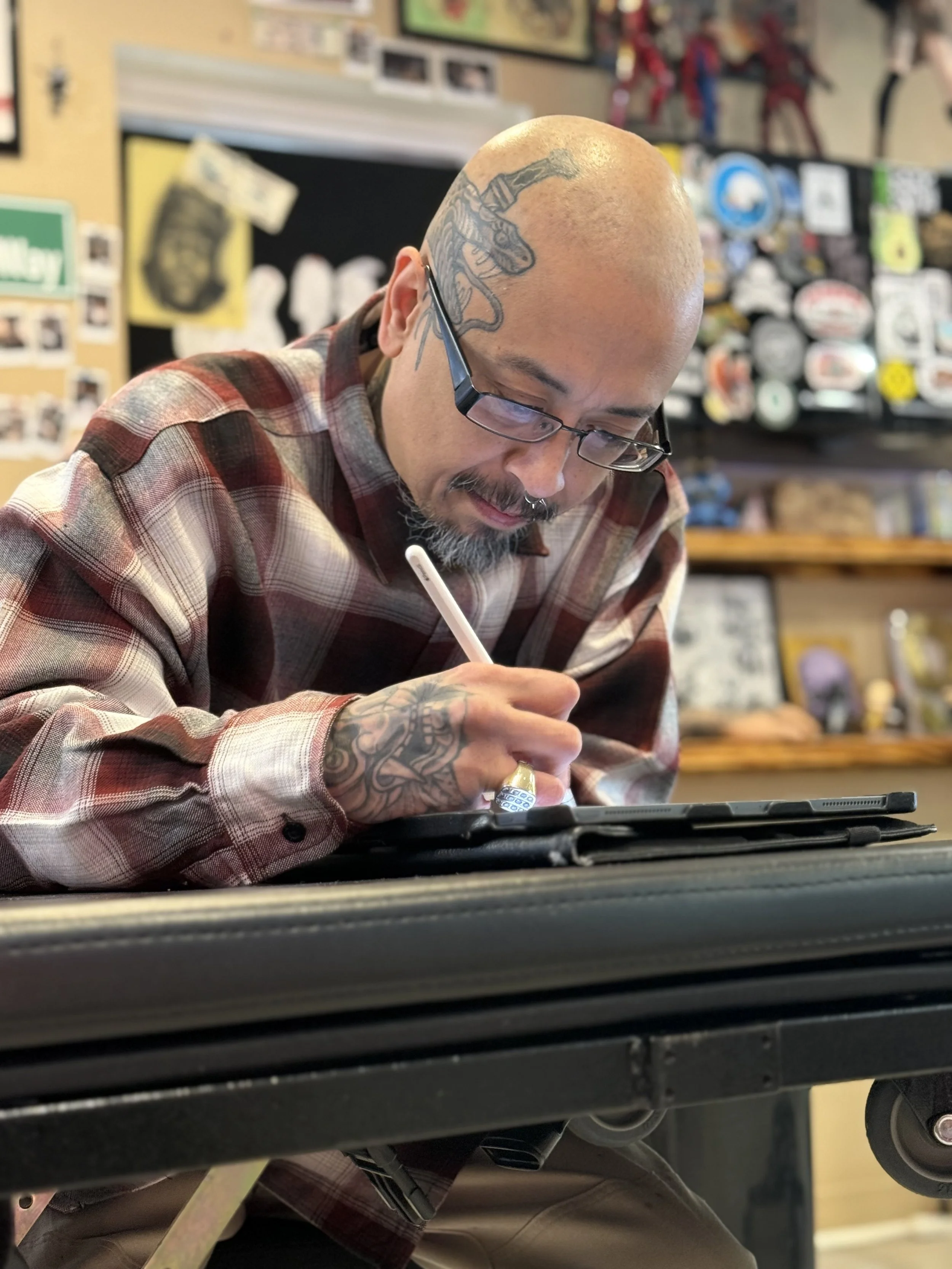 A master of his craft illustrating a custom tattoo commissioned by an awesome client. 