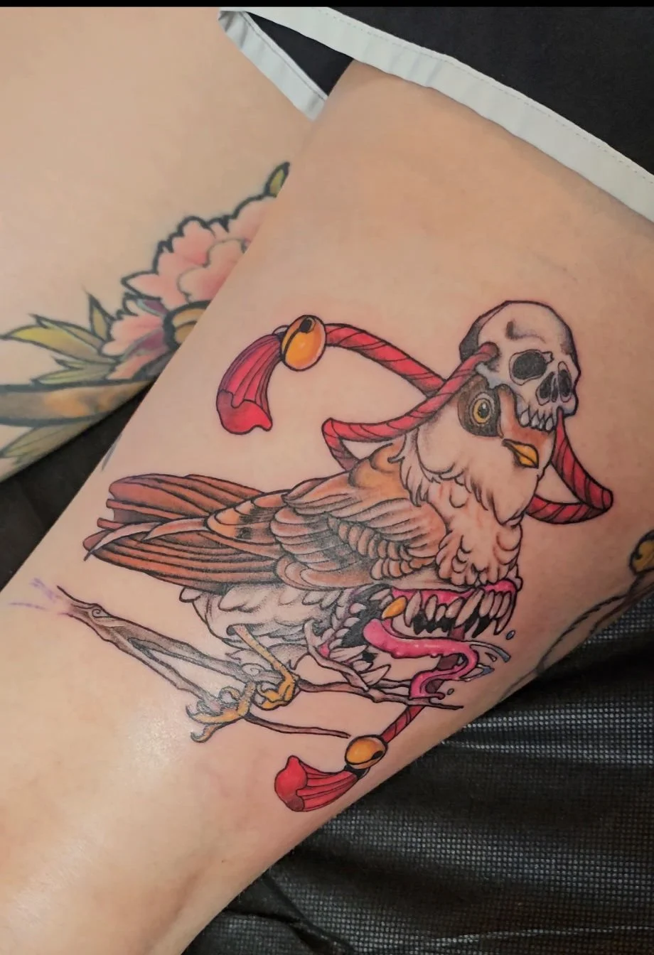 A nightmarish bird with a toothy maw where its stomach should be.  The bird wears a skull adorned with ropes on its head.